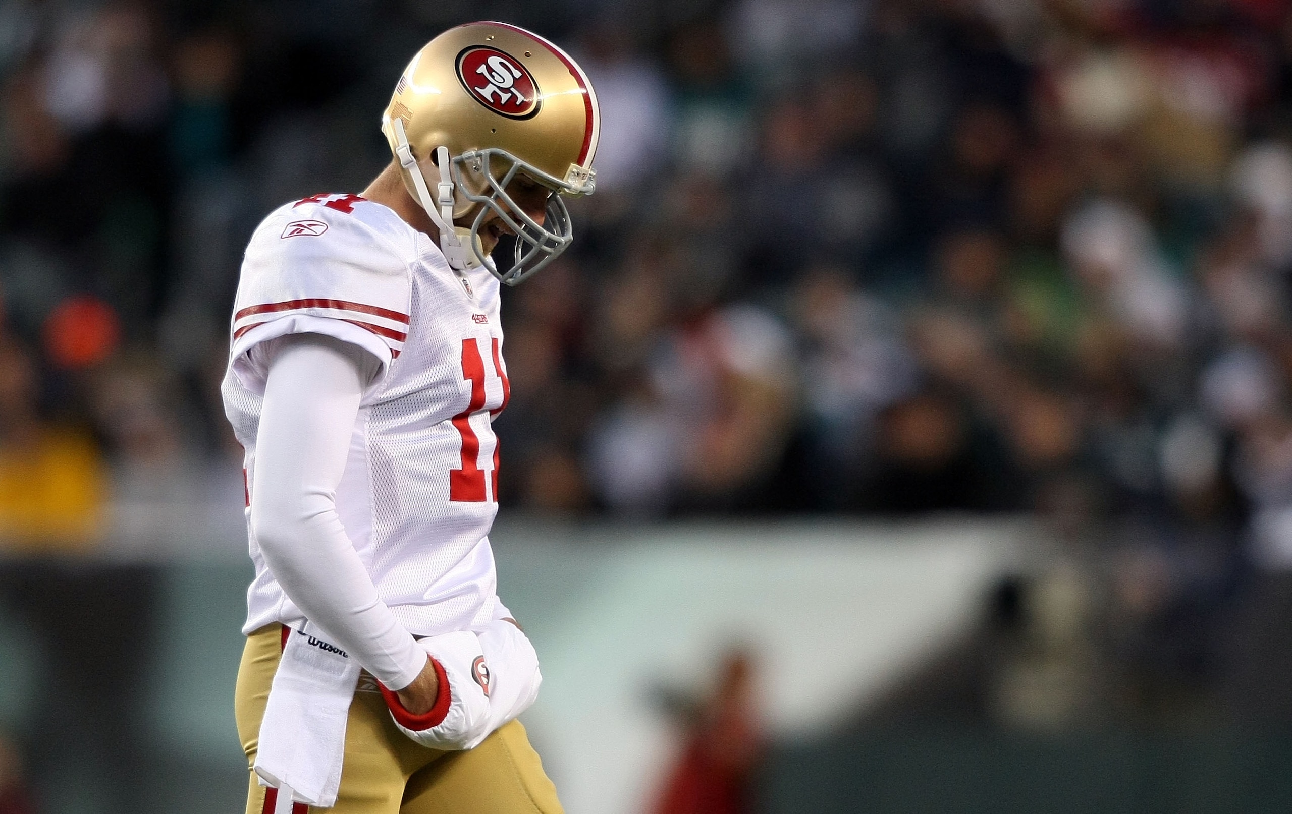 PHILADELPHIA - DECEMBER 20:  Alex Smith #11 of the San Francisco 49ers walks from the field after failing to complete a third down against the Philadelphia Eagles at Lincoln Financial Field on December 20, 2009 in Philadelphia, Pennsylvania.  (Photo by Ni