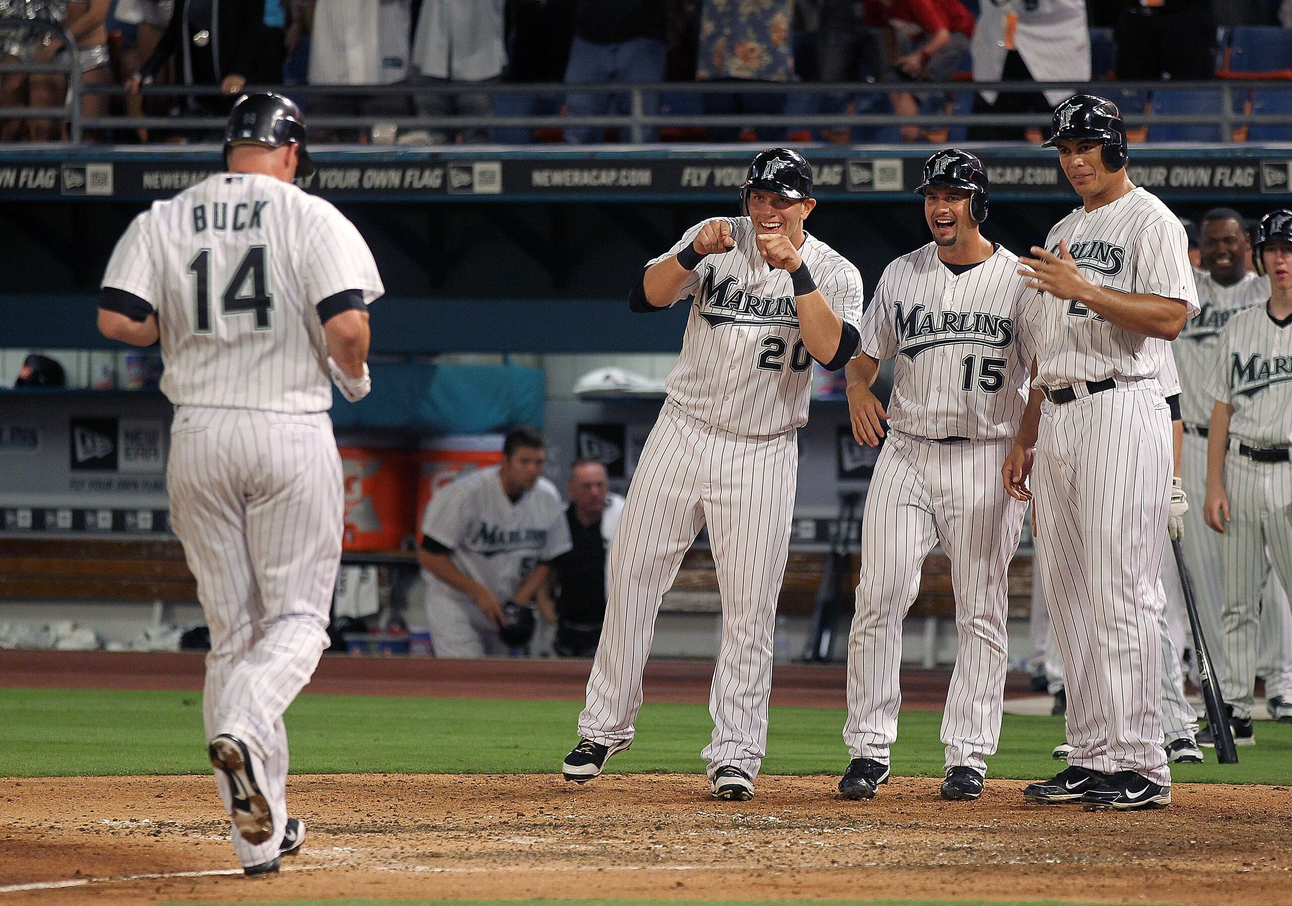 MIAMI GARDENS, FL - APRIL 01:  John Buck #14 of the Florida Marlins is greeted at home by Logan Morrison #20, Gaby Sanchez #15, and Mike Stanton #27 after hitting a grand slam during opening day against the New York Mets at Sun Life Stadium on April 1, 20