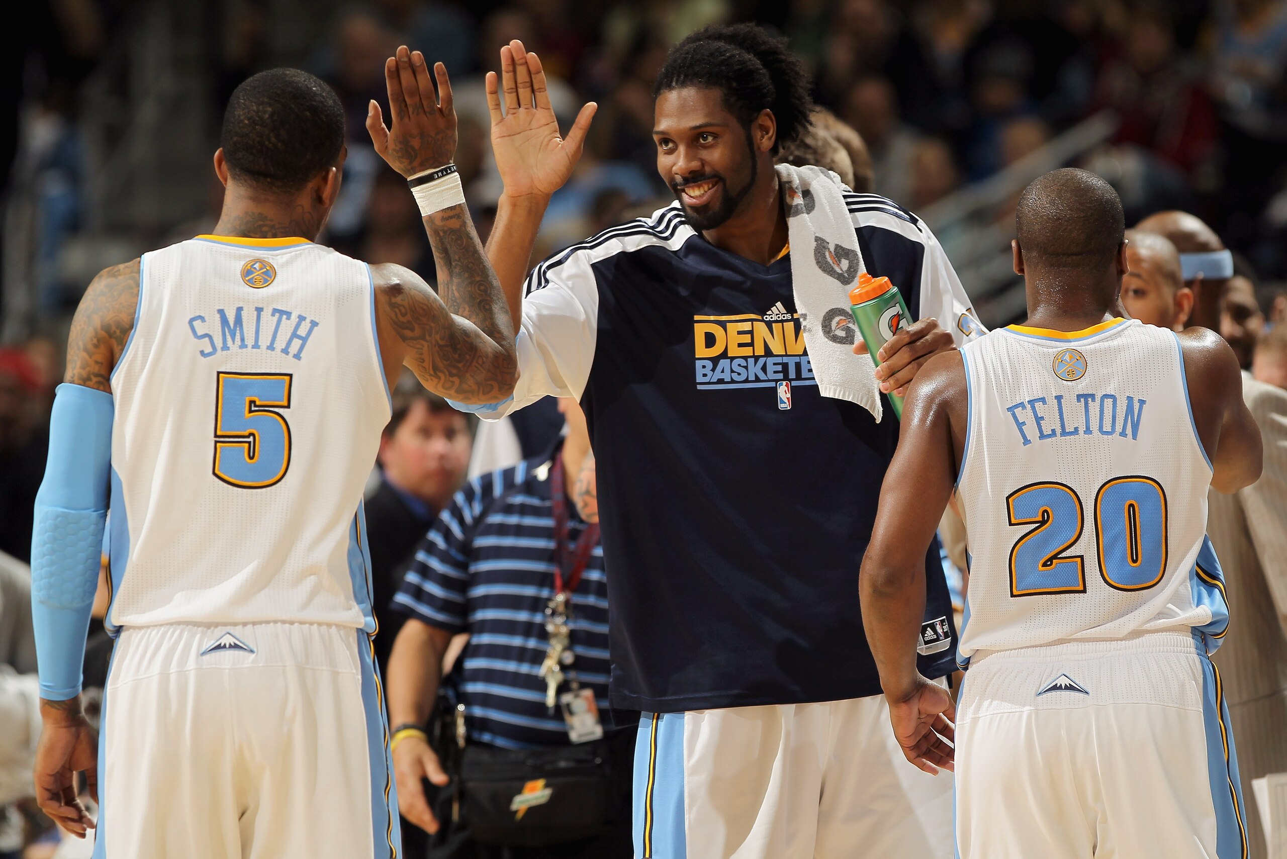DENVER, CO - MARCH 12: Nene #31 of the Denver Nuggets welcomes teammates J.R. Smith #5 and Raymond Felton #20 to the bench for a time out against the Detroit Pistons at the Pepsi Center on March 12, 2011 in Denver, Colorado. The Nuggets defeated the Pist DENVER, CO - MARCH 12: Nene #31 of the Denver Nuggets welcomes teammates J.R. Smith #5 and Raymond Felton #20 to the bench for a time out against the Detroit Pistons at the Pepsi Center on March 12, 2011 in Denver, Colorado. The Nuggets defeated the Pist