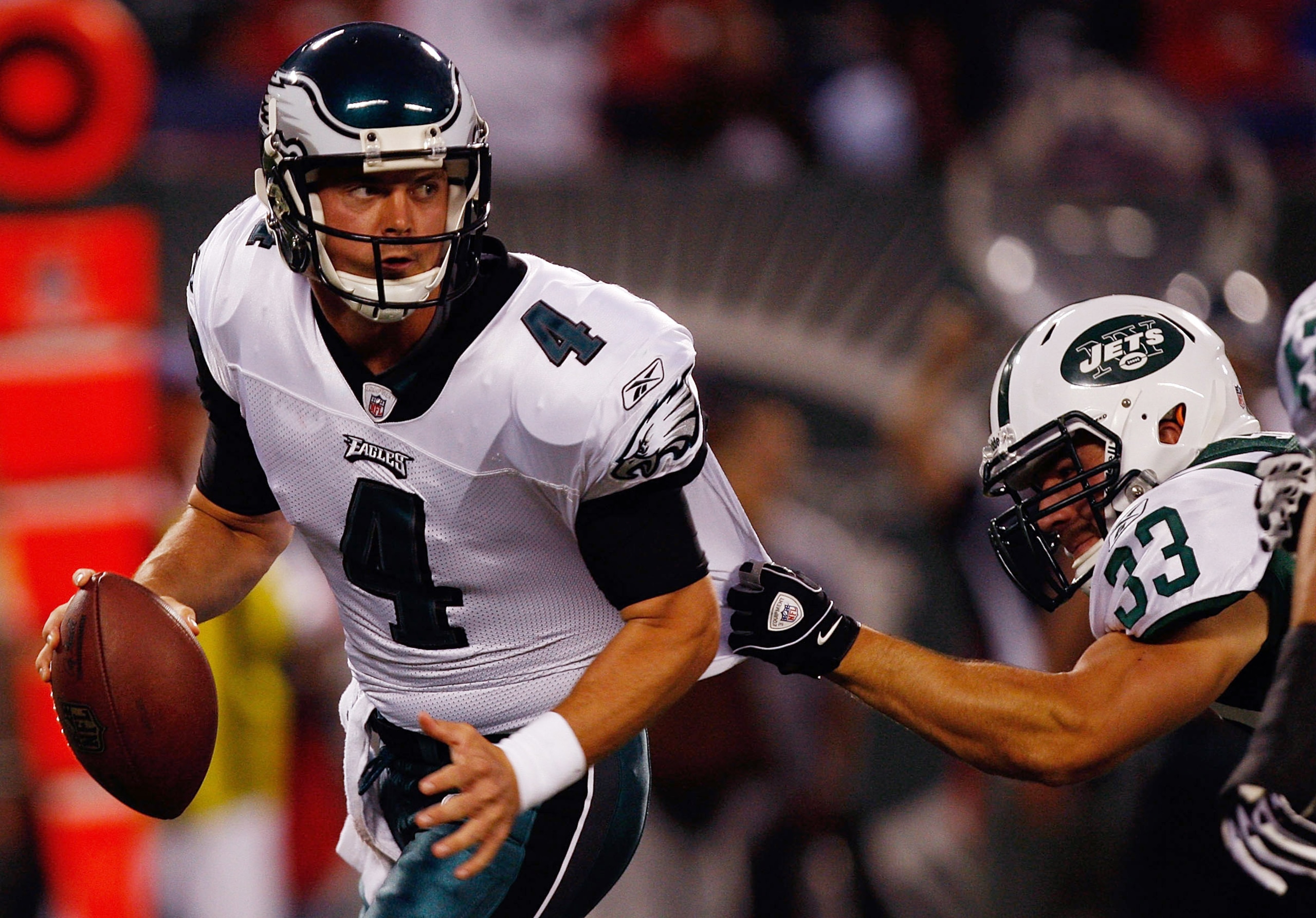 EAST RUTHERFORD, NJ - SEPTEMBER 3: Kevin Kolb #4 of the Philadelphia Eagles scambles away from Eric Smith #33 of the Philadelphia Eagles during the game on September 3, 2009 at Giants Stadium in East Rutherford, New Jersey. (Photo by Jared Wickerham/Getty