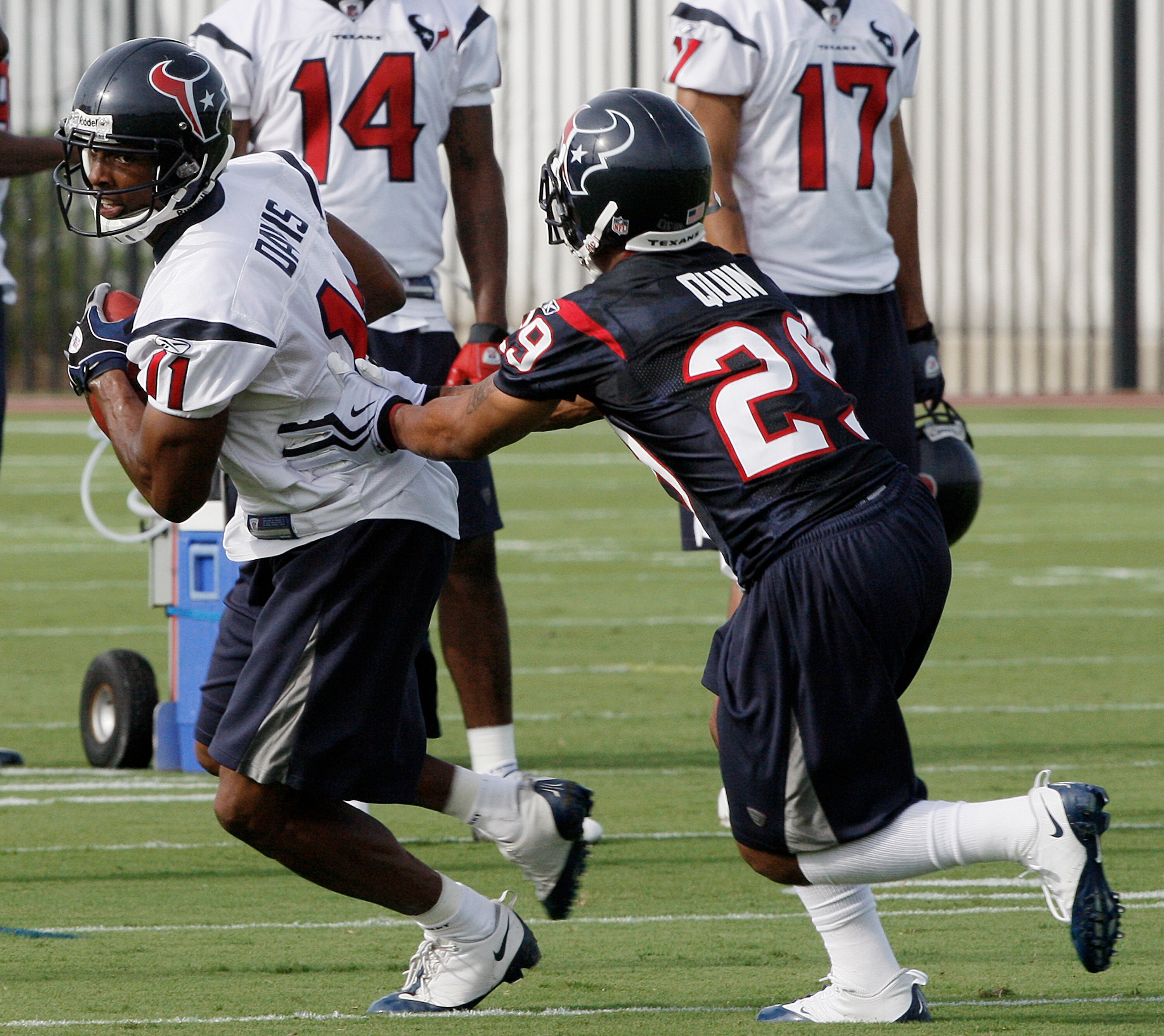 HOUSTON - JULY 31:  Wide receiver Andre Johnson #11 of the Houston Texans attempts to evade cornerback Glover Quinn #29 during Texans training camp on July 31, 2009 in Houston, Texas.  (Photo by Bob Levey/Getty Images)