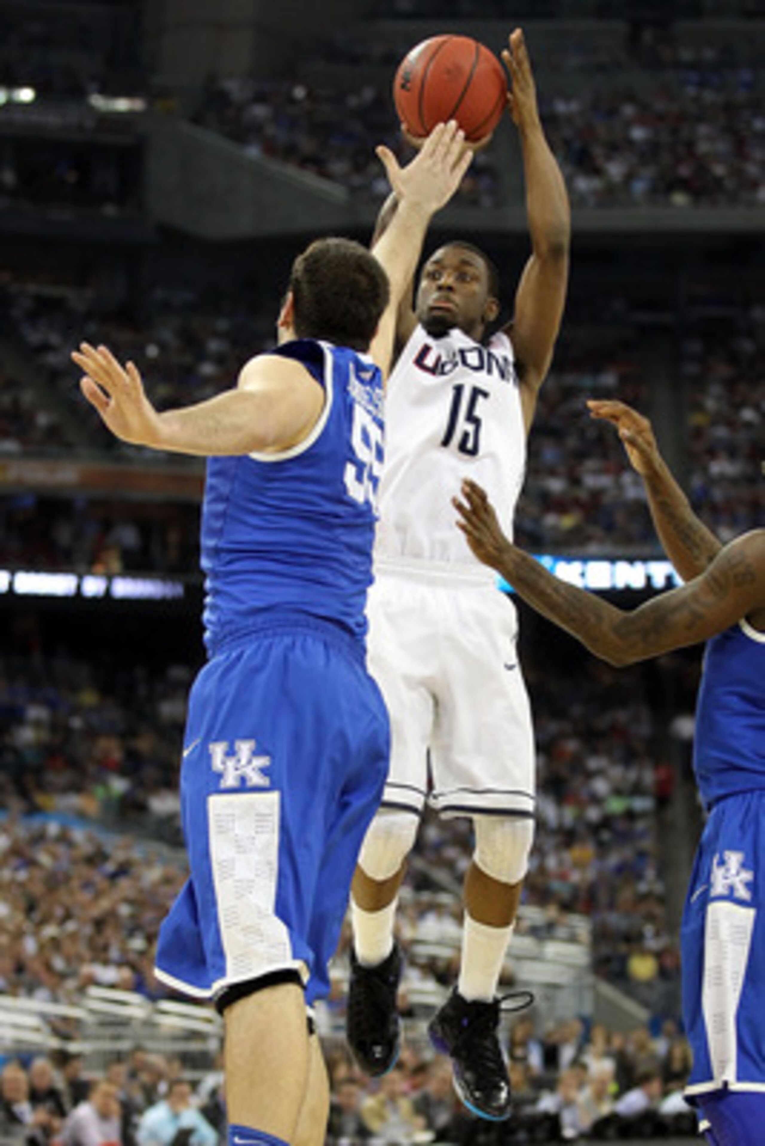 HOUSTON, TX - APRIL 02:  Kemba Walker #15 of the Connecticut Huskies shoots over Josh Harrellson #55 of the Kentucky Wildcats during the National Semifinal game of the 2011 NCAA Division I Men's Basketball Championship at Reliant Stadium on April 2, 2011