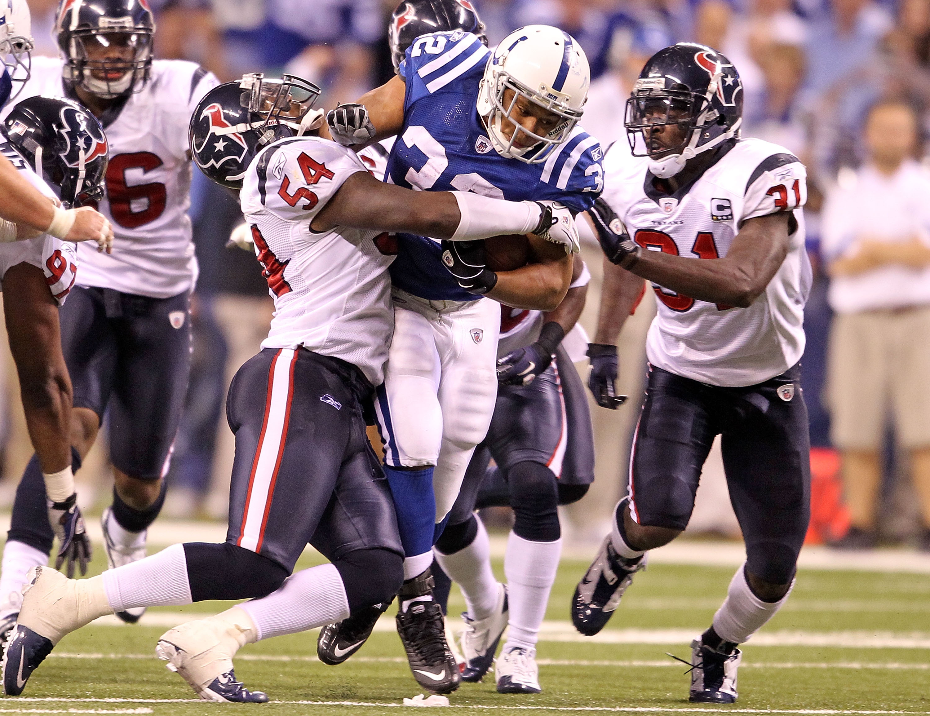INDIANAPOLIS - NOVEMBER 01:  Mike Hart #32 of Indianapolis Colts runs with the ball while tackled by Zac Diles #54  and Bernard Pollard #31 of the Houston Texans during the NFL game at Lucas Oil Stadium on November 1, 2010 in Indianapolis, Indiana.  (Phot