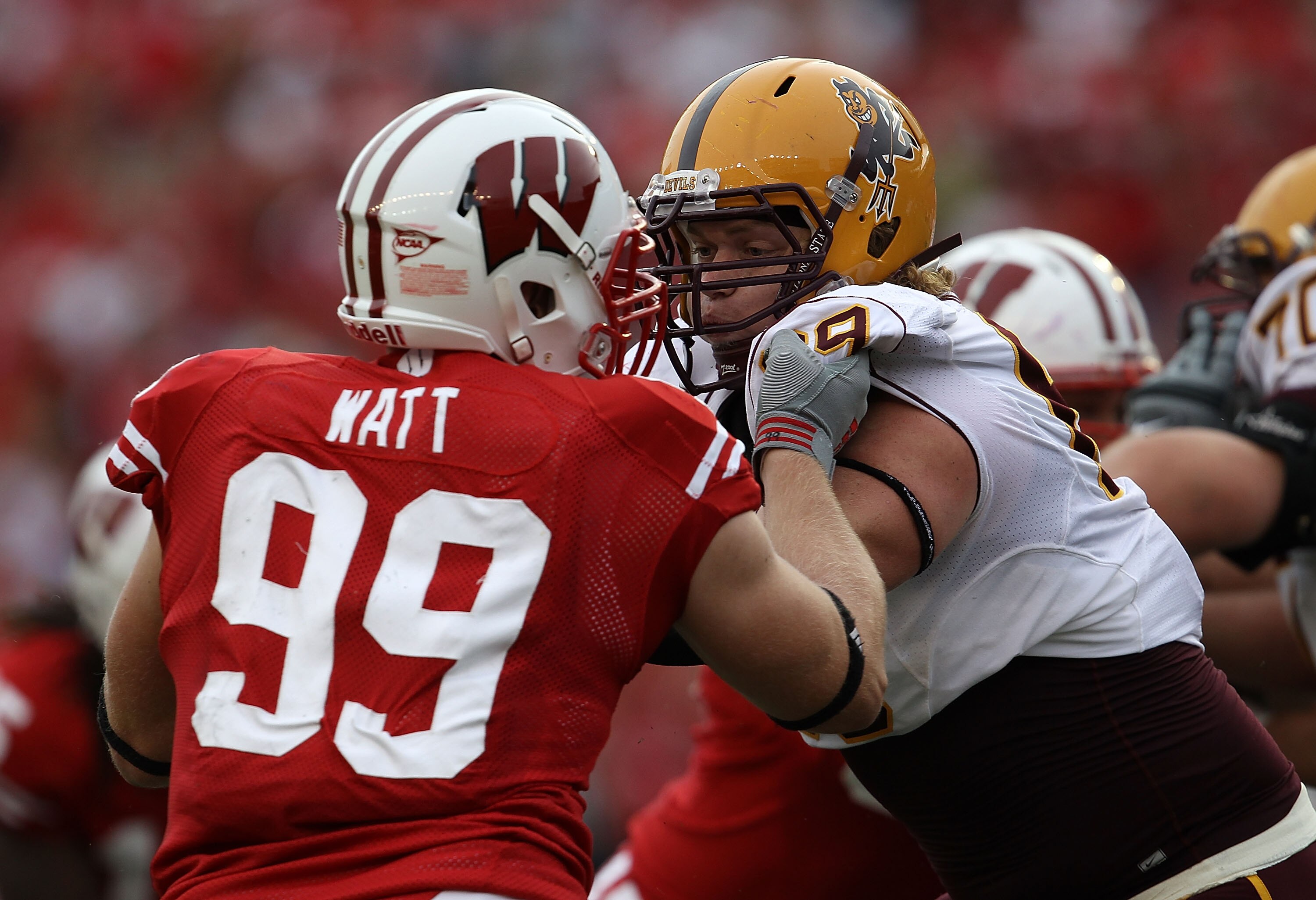 MADISON, WI - SEPTEMBER 18: Dan Knapp #69 of the Arizona State Sun Devils blocks against J.J. Watt #99 of the Wisconsin Badgers at Camp Randall Stadium on September 18, 2010 in Madison, Wisconsin. Wisconsin defeated Arizona State 20-19.  (Photo by Jonatha