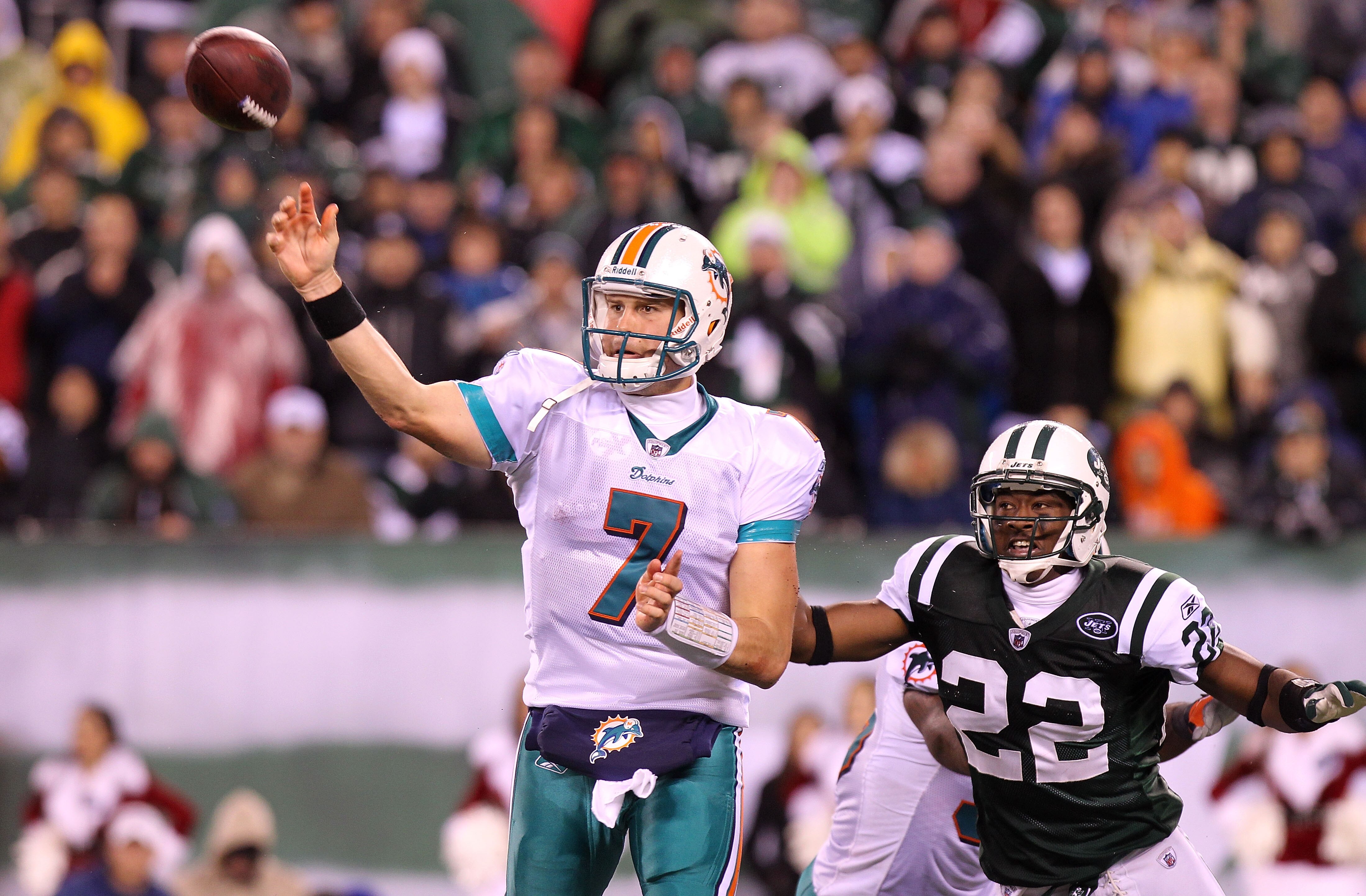 EAST RUTHERFORD, NJ - DECEMBER 12:  Chad Henne #7 of the Miami Dolphins passes under pressure from Brodney Pool #22 of the New York Jets at New Meadowlands Stadium on December 12, 2010 in East Rutherford, New Jersey.  (Photo by Nick Laham/Getty Images)