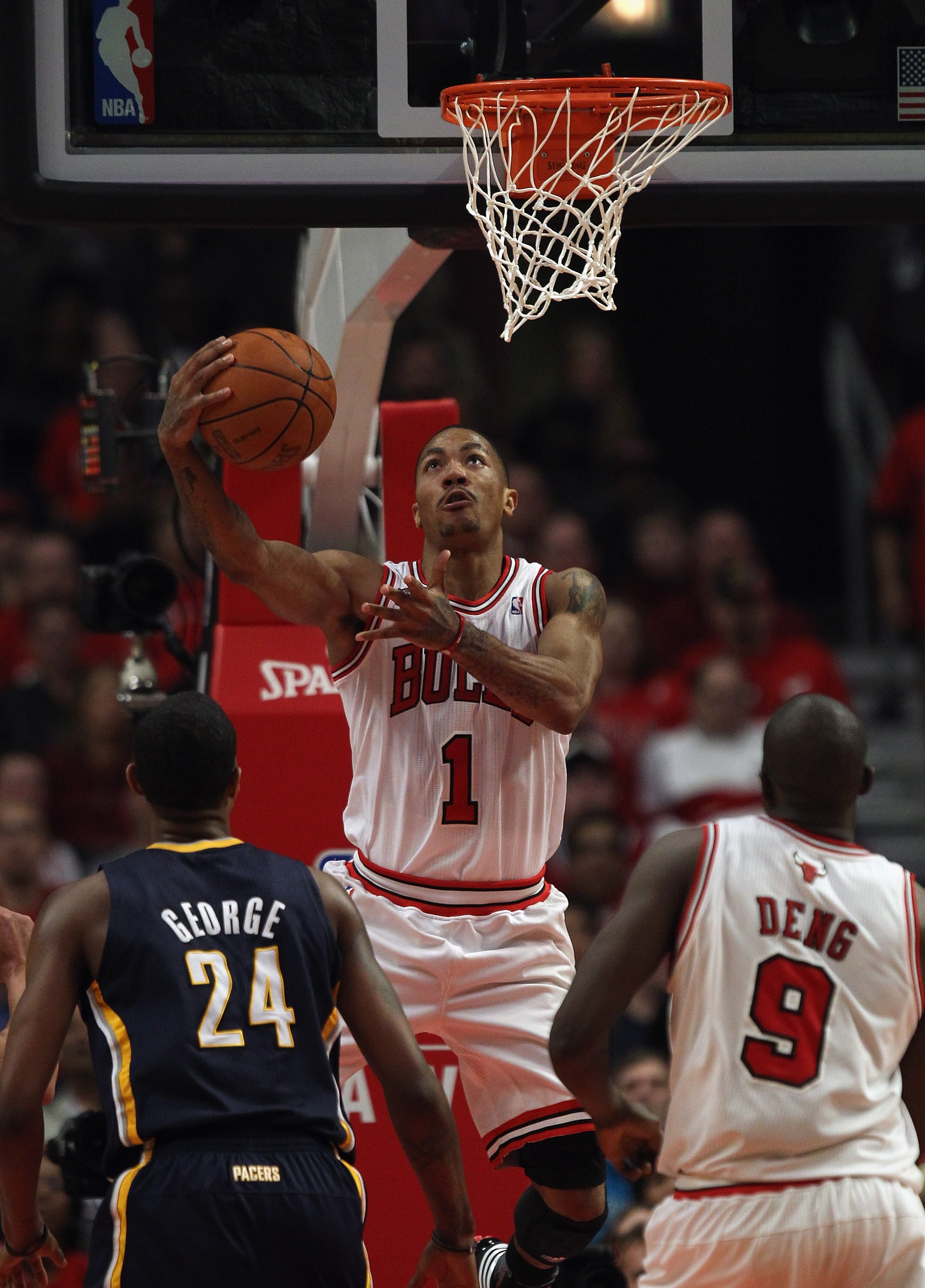 CHICAGO, IL - APRIL 18: Derrick Rose #1 of the Chicago Bulls puts up a shot over teammate Loul Deng #9 and Paul George #24 of the Indiana Pacers in Game Two of the Eastern Conference Quarterfinals in the 2011 NBA Playoffs at the United Center on April 18,
