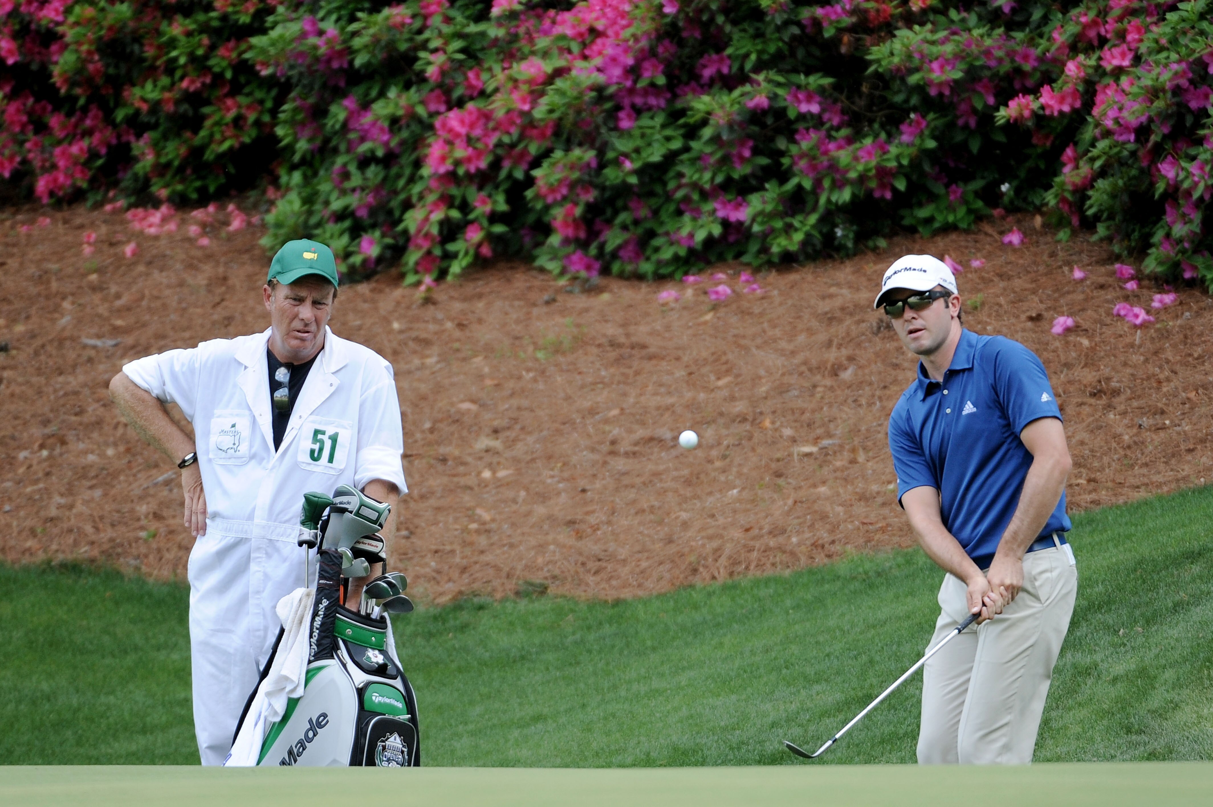 AUGUSTA, GA - APRIL 10:  Martin Laird of Scotland (R) chips to a green as caddie Alan Bond looks on during the final round of the 2011 Masters Tournament at Augusta National Golf Club on April 10, 2011 in Augusta, Georgia.  (Photo by Harry How/Getty Image