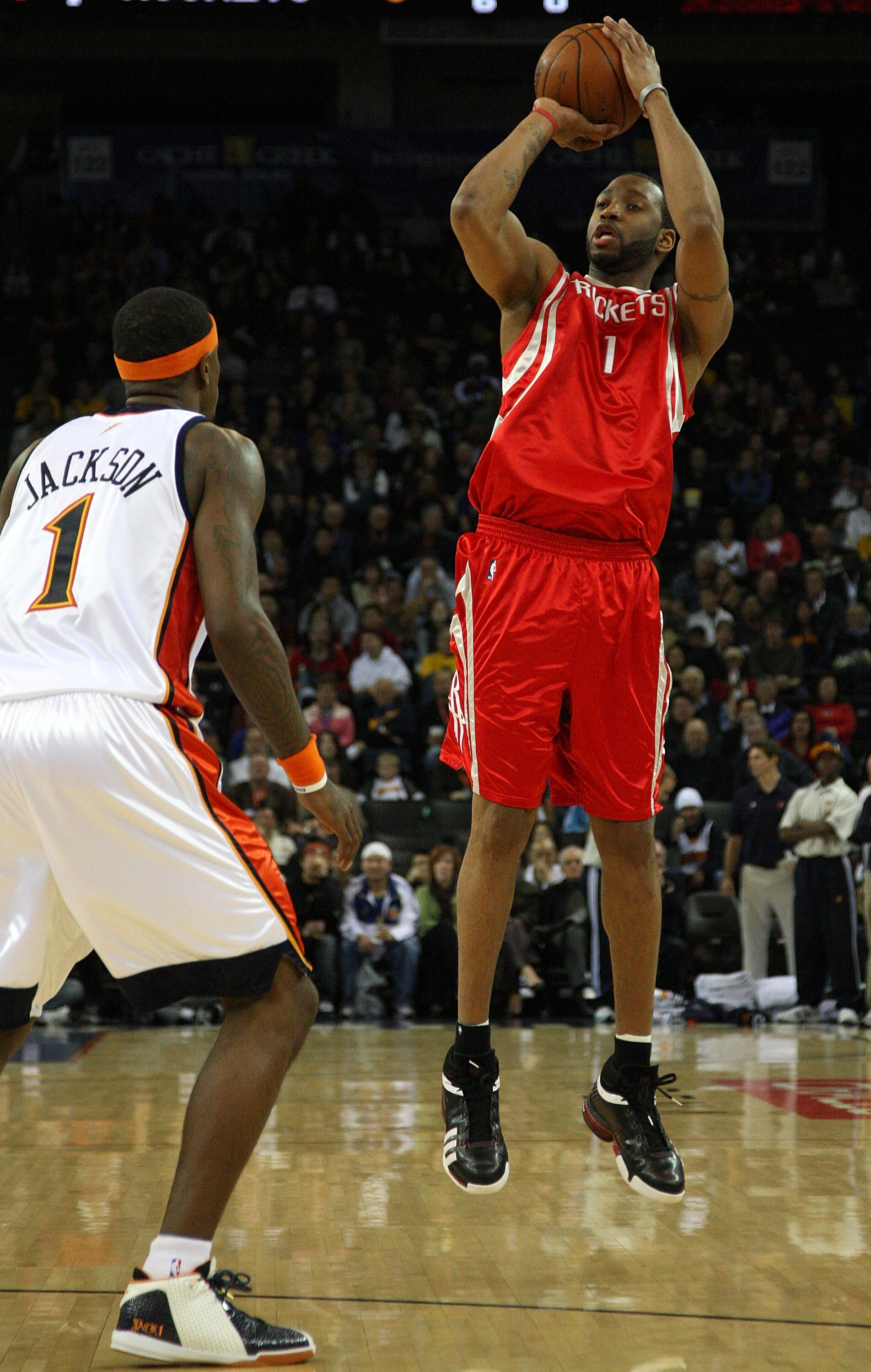 OAKLAND, CA - DECEMBER 12:  Tracy McGrady #1 of the Houston Rockets shoots over Stephen Jackson #1 of the Golden State Warriors during an NBA game on December 12, 2008 at Oracle Arena in Oakland, California. NOTE TO USER: User expressly acknowledges and a