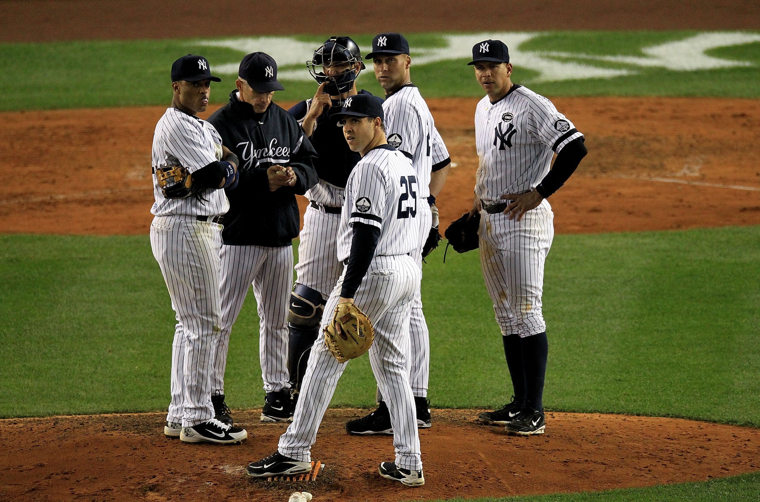 NEW YORK - OCTOBER 18: Manager Joe Girardi, Jorge Posada #20, Mark Teixeira #25, Robinson Cano #24, Alex Rodriguez #13 and Derek Jeter #2 of the New York Yankees look on during a pitching change against the Texas Rangers in Game Three of the ALCS during NEW YORK - OCTOBER 18: Manager Joe Girardi, Jorge Posada #20, Mark Teixeira #25, Robinson Cano #24, Alex Rodriguez #13 and Derek Jeter #2 of the New York Yankees look on during a pitching change against the Texas Rangers in Game Three of the ALCS during