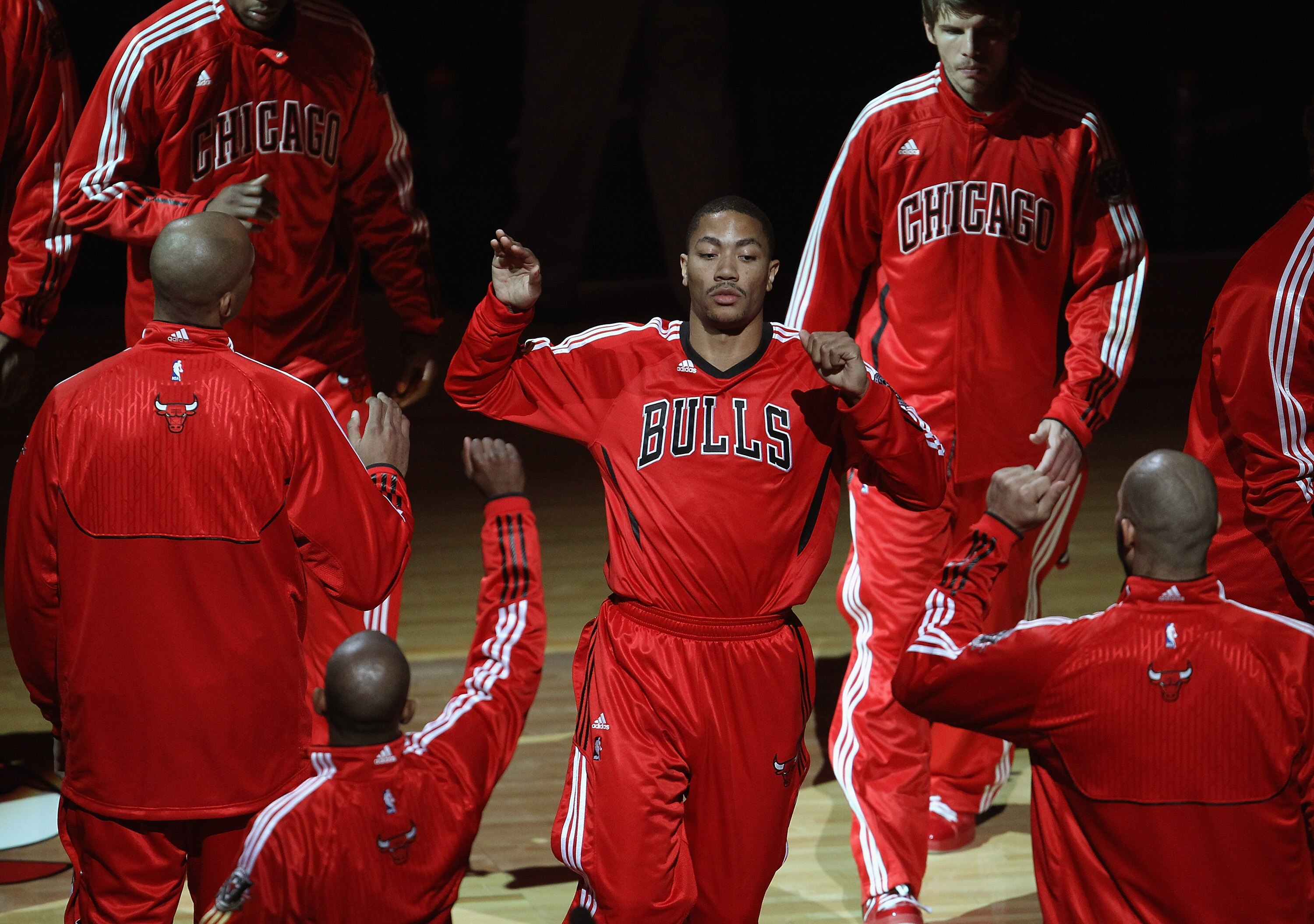 CHICAGO, IL - APRIL 13: Derrick Rose #1 of the Chicago Bulls is greeted by teammates during player introductions before a game against the New Jersey Nets at United Center on April 13, 2011 in Chicago, Illinois. The Bulls defeated the Nets 97-92. NOTE TO 