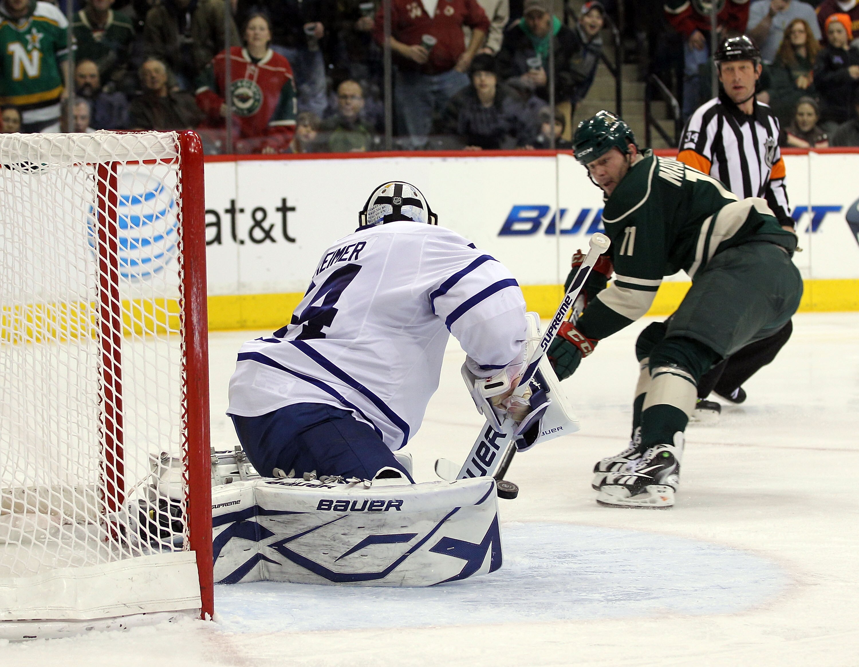 ST PAUL, MN - MARCH 22: John Madden #11 of the Minnesota Wild is stopped on a second period breakaway by James Reimer #34 of the Toronto Maple Leafs  at the Xcel Energy Center on March 22, 2011 in St Paul, Minnesota. (Photo by Bruce Bennett/Getty Images)