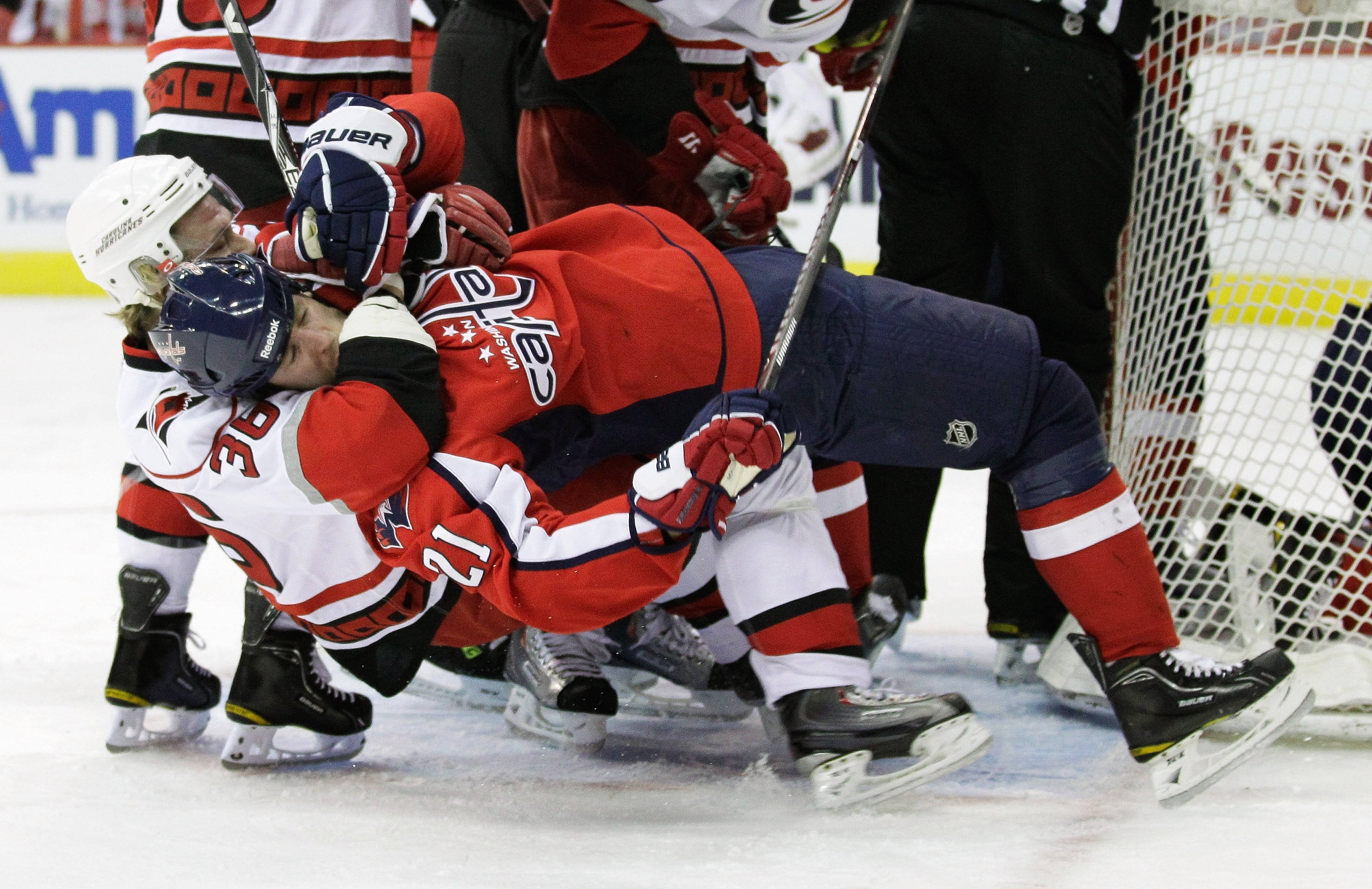 WASHINGTON, DC - MARCH 29:  Jussi Jokinen #36 of the Carolina Hurricanes pulls Brooks Laich #21 of the Washington Capitals to the ice during the first period at the Verizon Center on March 29, 2011 in Washington, DC.  (Photo by Rob Carr/Getty Images)