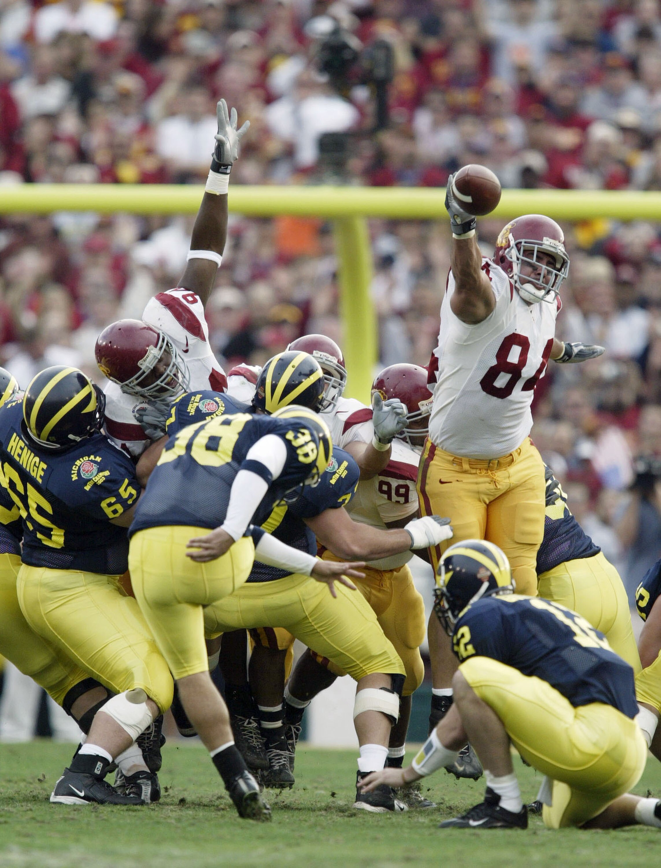 PASADENA, CA - JANUARY 1:  Defensive lineman Shaun Cody #84 of the USC Trojans breaks throught to block a field goal attempt by B.J. Opong-Owusu #38 of the Michigan Wolverines during the 2004 Rose Bowl on January 1, 2004 at the Rose Bowl in Pasadena, Cali