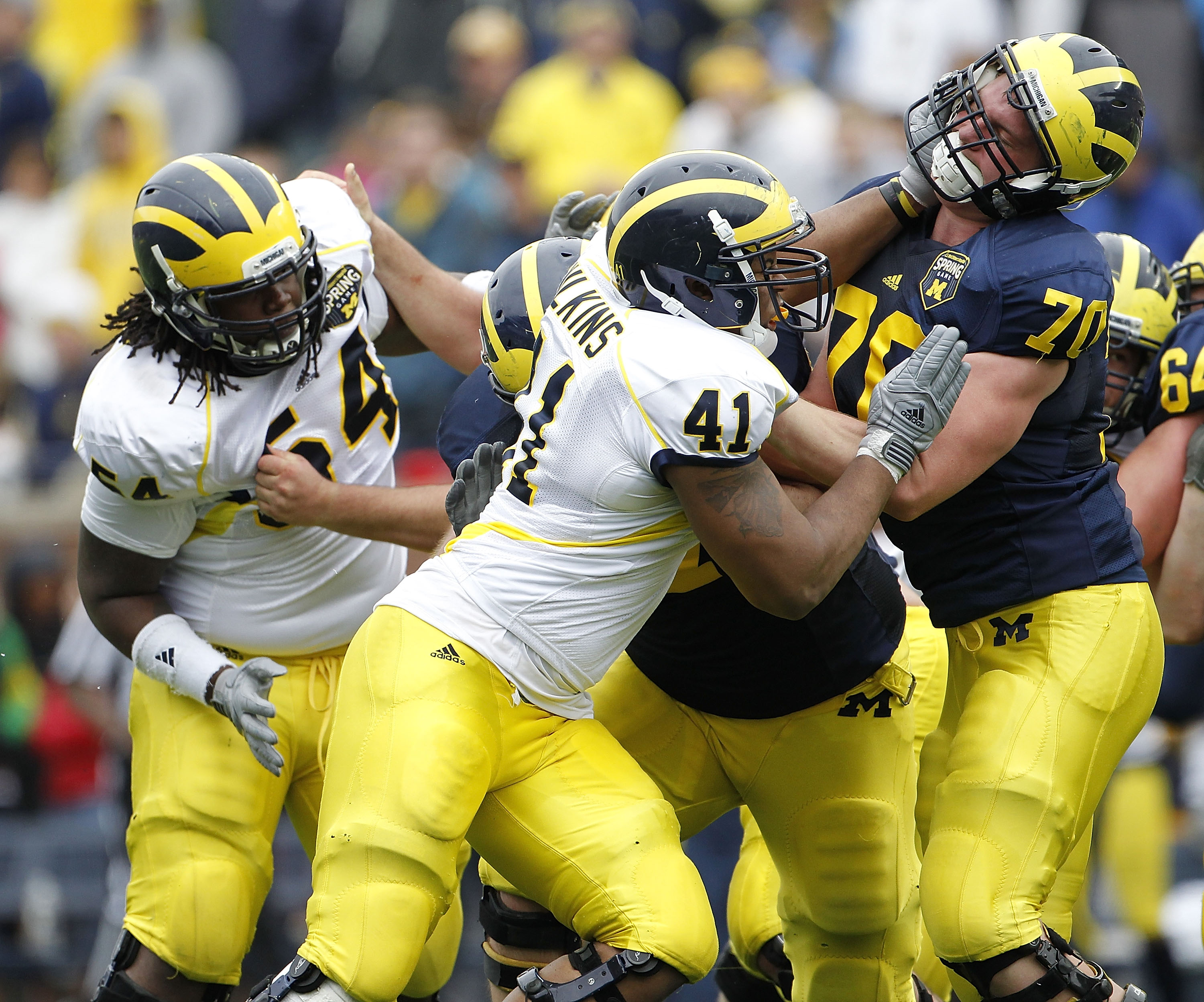 ANN ARBOR, MI - APRIL 16: Kenny Wilkins #41 and Kristian Mateus #70 of the Michigan Wolverines battle during the annual Spring Game at Michigan Stadium on April 16, 2011 in Ann Arbor, Michigan.  (Photo by Leon Halip/Getty Images)