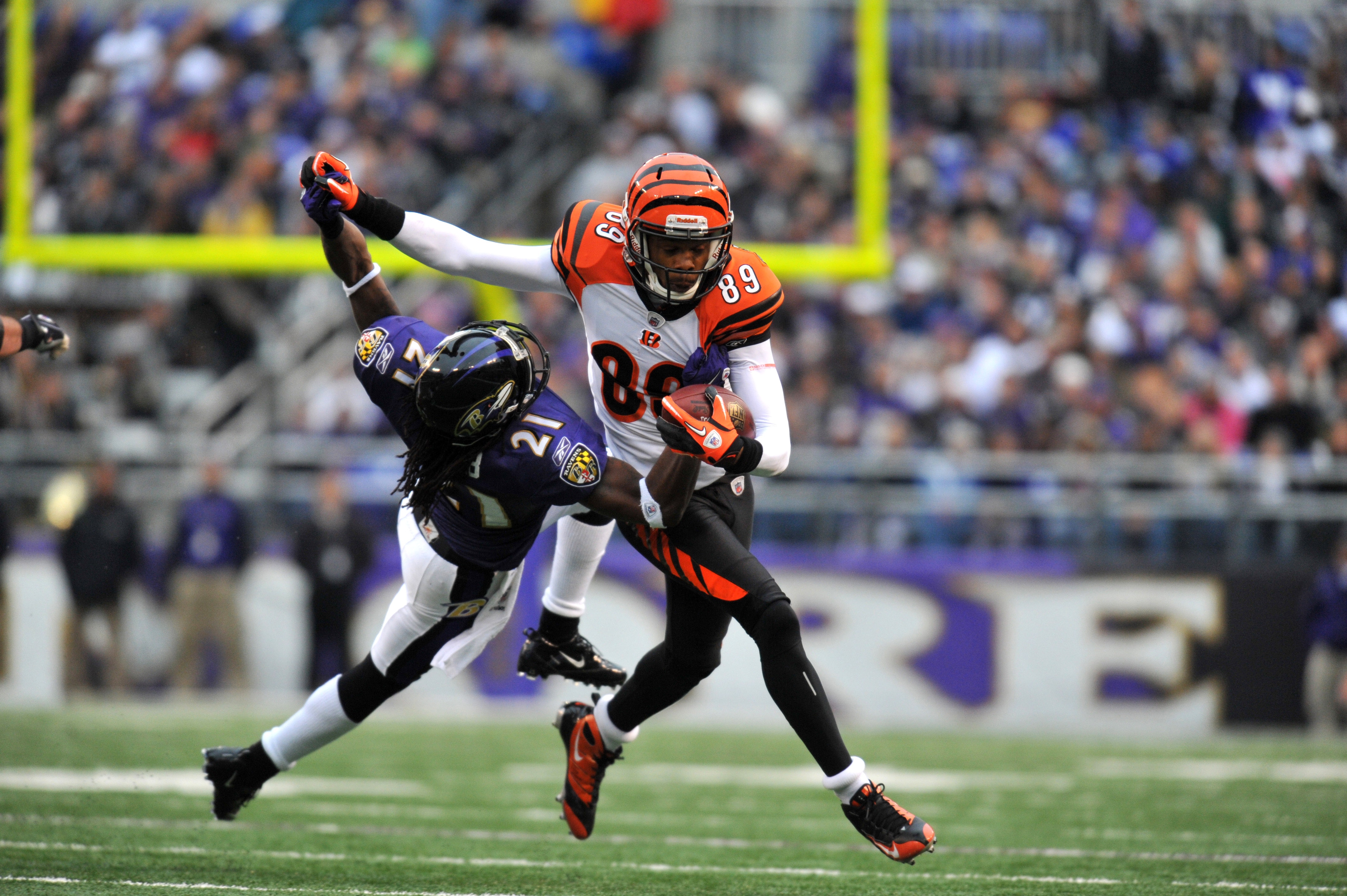 BALTIMORE, MD - JANUARY 2:  Jerome Simpson #89 of the Cincinnati Bengals runs the ball against Lardarius Webb #21 of the Baltimore Ravens at M&T Bank Stadium on January 2, 2011 in Baltimore, Maryland. The Ravens lead the Bengals 6-0 at the half. (Photo by