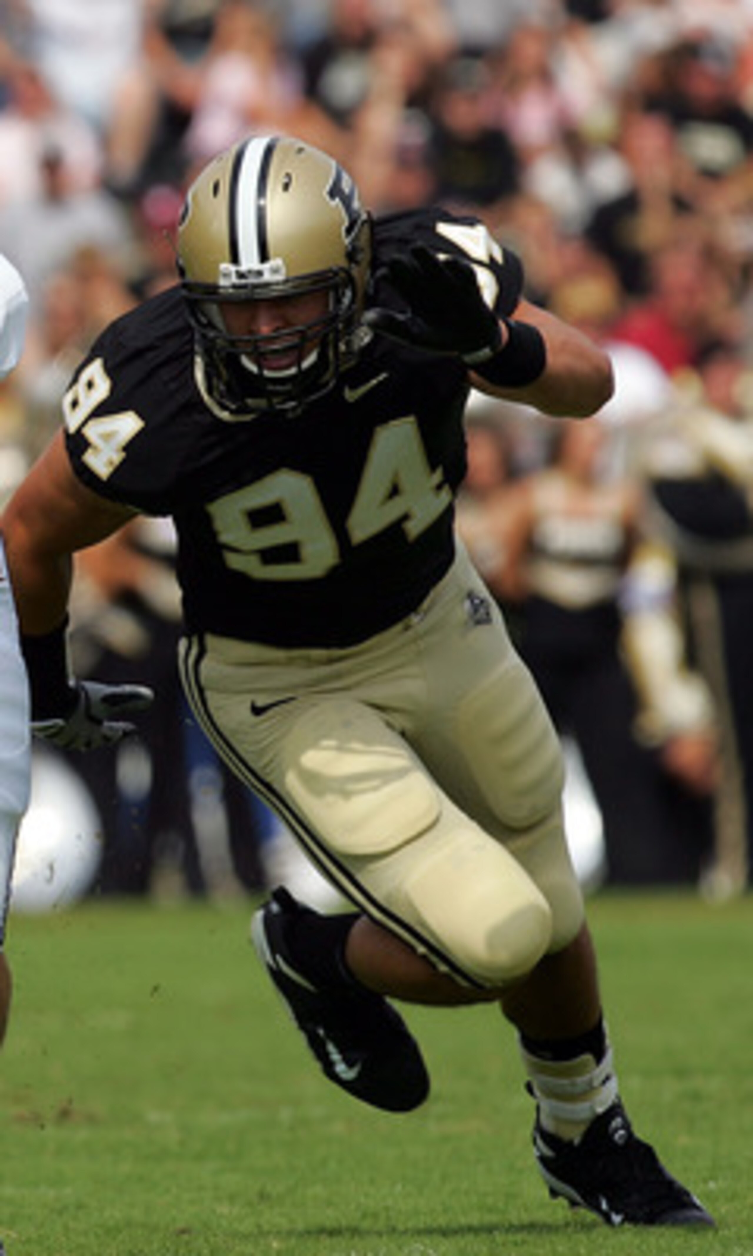 WEST LAFAYETTE, IN - SEPTEMBER 20:  Quarterback Dan LeFevour #13 of the Central Michigan Chippewas runs the ball past Ryan Kerrigan #94 of the Purdue Boilermakers at Ross-Ade Stadium on September 20, 2008 in West Lafayette, Indiana.  (Photo by Ronald Mart