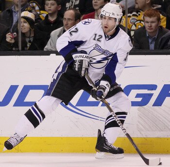 BOSTON, MA - MARCH 03:  Simon Gagne #12 of the Tampa Bay Lightning looks to pass in the second period against the Boston Bruins on March 3, 2011 at the TD Garden in Boston, Massachusetts.  (Photo by Elsa/Getty Images)