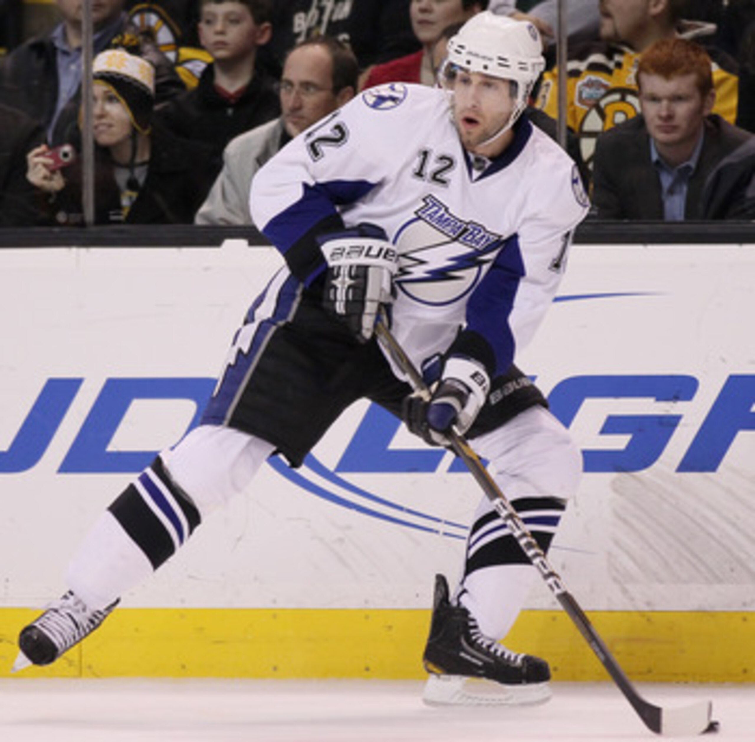 BOSTON, MA - MARCH 03:  Simon Gagne #12 of the Tampa Bay Lightning looks to pass in the second period against the Boston Bruins on March 3, 2011 at the TD Garden in Boston, Massachusetts.  (Photo by Elsa/Getty Images)