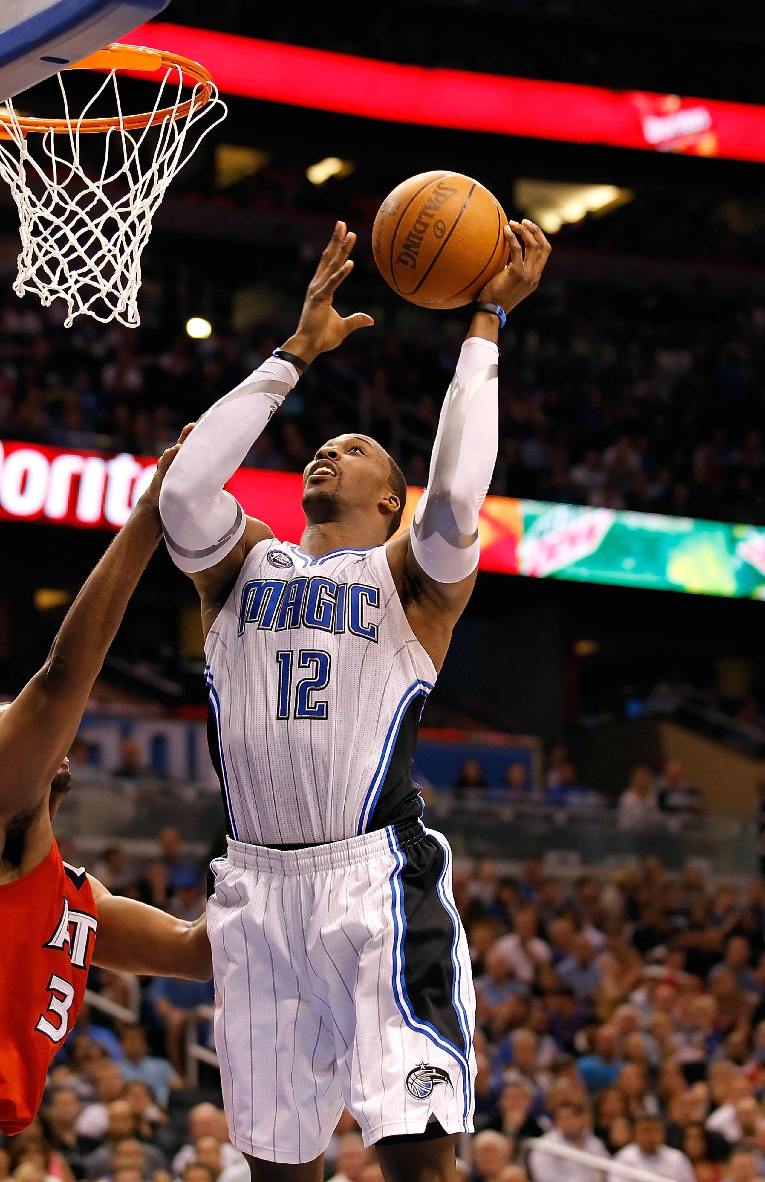 ORLANDO, FL - APRIL 16:  Dwight Howard #12 of the Orlando Magic lays the ball up against the Atlanta Hawks during Game One of the Eastern Conference Quarterfinals of the 2011 NBA Playoffs on April 16, 2011 at the Amway Arena in Orlando, Florida.  NOTE TO