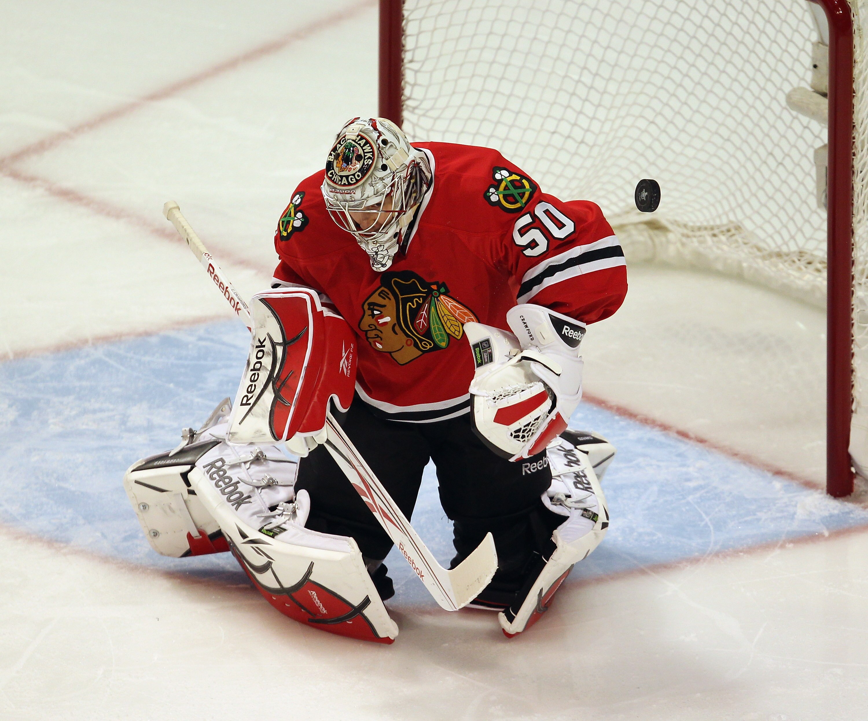 CHICAGO, IL - APRIL 17: Corey Crawford #50 of the Chicago Blackhawks makes a save off of his shoulder against the Vancouver Canucks in Game Three of the Western Conference Quarterfinals during the 2011 NHL Stanley Cup Playoffs at the United Center on Apri