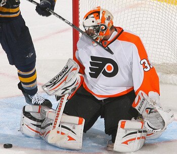 BUFFALO, NY - APRIL 18: Braydon Coburn #5 and Brian Boucher of the Philadelphia Flyers defend against Paul Gaustad #28  of the Buffalo Sabres  in Game Three of the Eastern Conference Quarterfinals during the 2011 NHL Stanley Cup Playoffs at HSBC Arena at