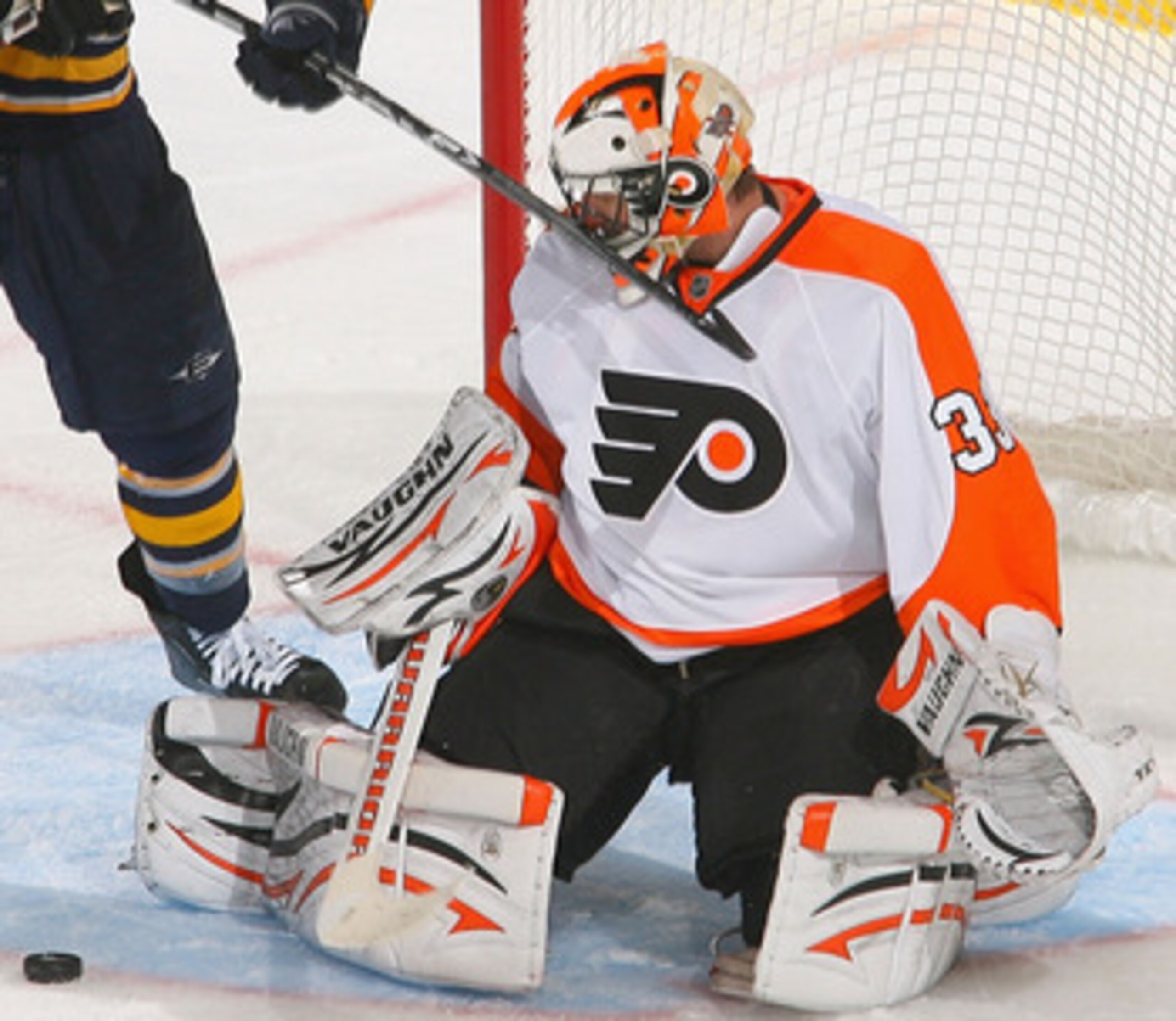BUFFALO, NY - APRIL 18: Braydon Coburn #5 and Brian Boucher of the Philadelphia Flyers defend against Paul Gaustad #28  of the Buffalo Sabres  in Game Three of the Eastern Conference Quarterfinals during the 2011 NHL Stanley Cup Playoffs at HSBC Arena at