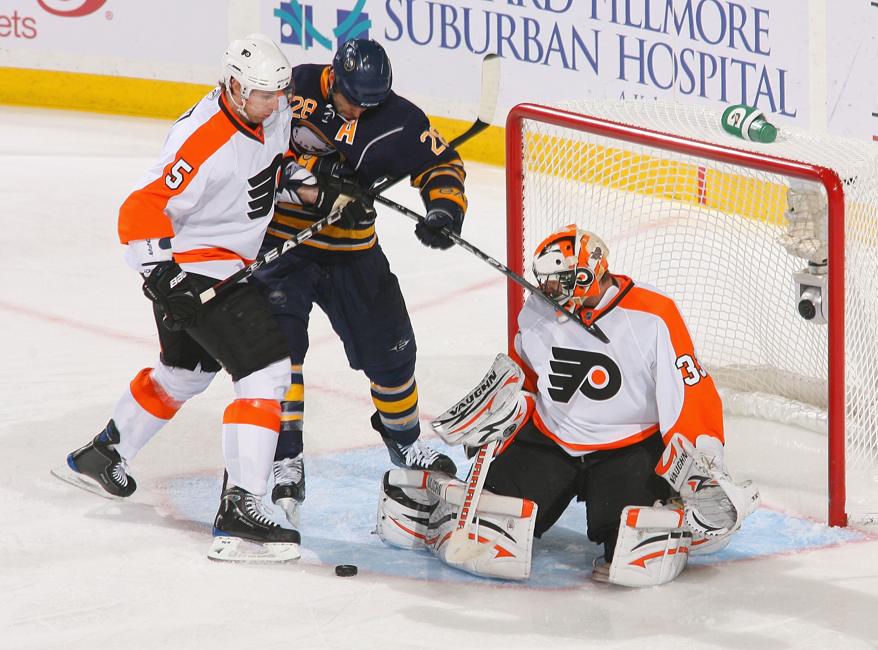BUFFALO, NY - APRIL 18: Braydon Coburn #5 and Brian Boucher of the Philadelphia Flyers defend against Paul Gaustad #28  of the Buffalo Sabres  in Game Three of the Eastern Conference Quarterfinals during the 2011 NHL Stanley Cup Playoffs at HSBC Arena at