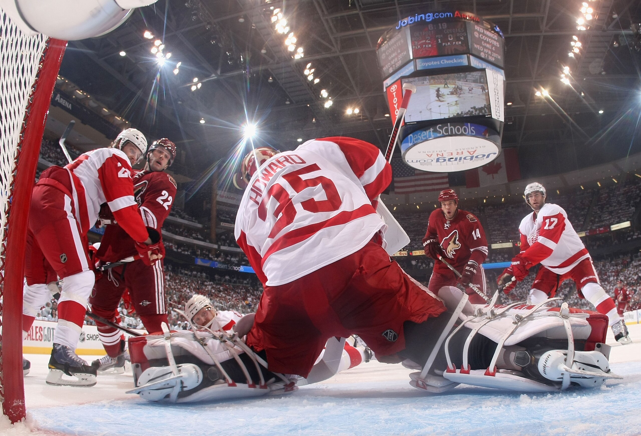 GLENDALE, AZ - APRIL 18:  Goaltender Jimmy Howard #35 of the Detroit Red Wings makes a save on the shot as Lee Stempniak #22 and Taylor Pyatt #14 of the Phoenix Coyotes skate in in Game Three of the Western Conference Quarterfinals during the 2011 NHL Sta