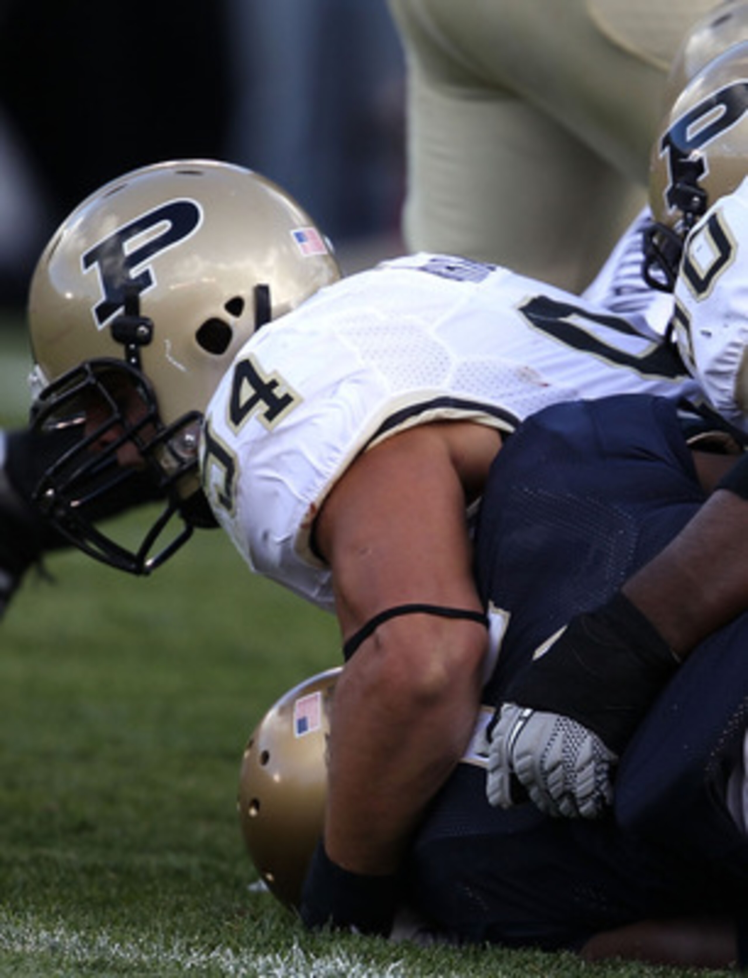 SOUTH BEND, IN - SEPTEMBER 04: Armando Allen Jr., #5 of the Notre Dame Fighting Irish is tackled in the end zone for a safety by Ryan Kerrigan #94 and Bruce Gaston #90 of the Purdue Boilermakers at Notre Dame Stadium on September 4, 2010 in South Bend, In