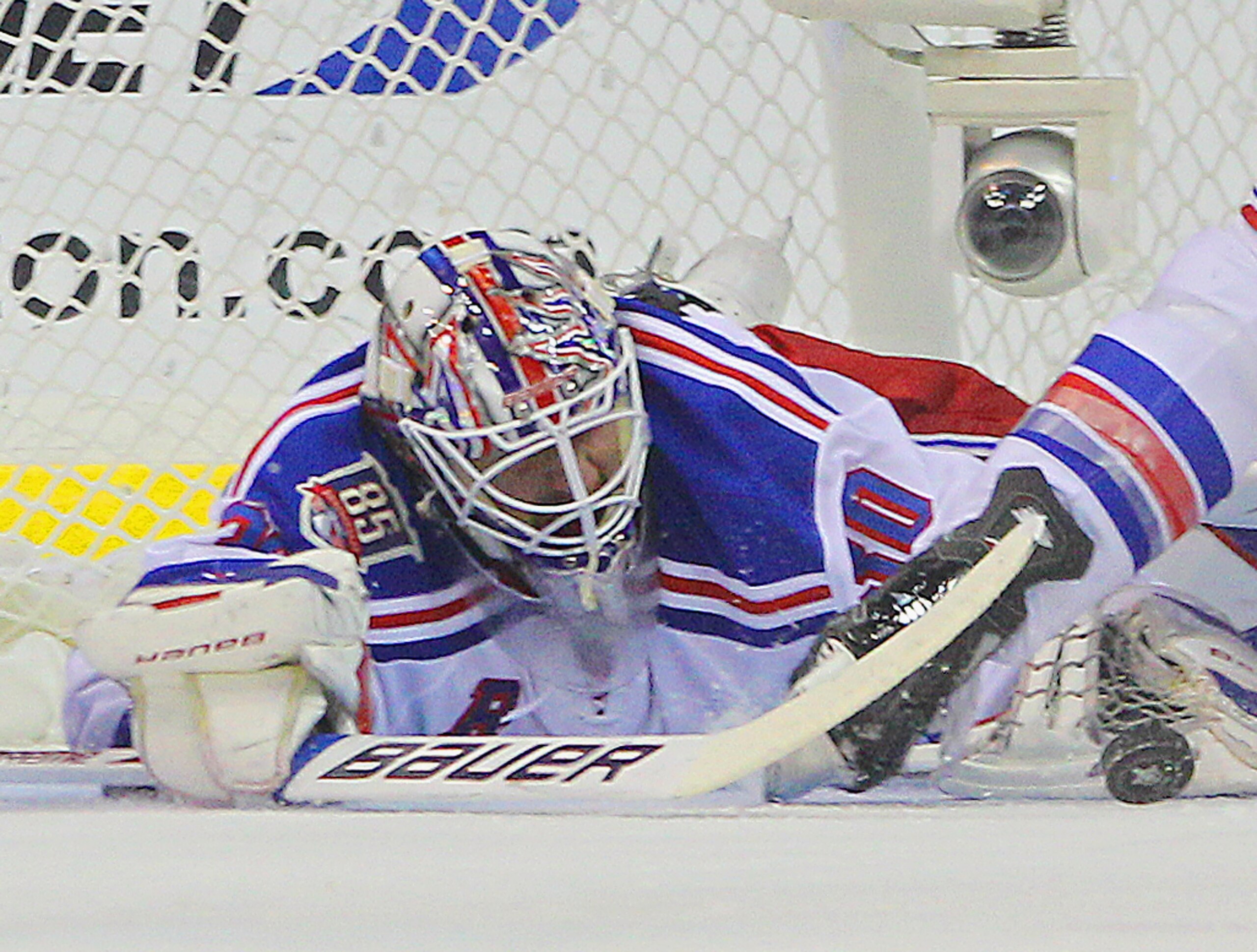 WASHINGTON, DC - APRIL 15:  Henrik Lundqvist #30 of the New York Rangers makes the first period save against the Washington Capitals in Game Two of the Eastern Conference Quarterfinals during the 2011 NHL Stanley Cup Playoffs at Verizon Center on April 15