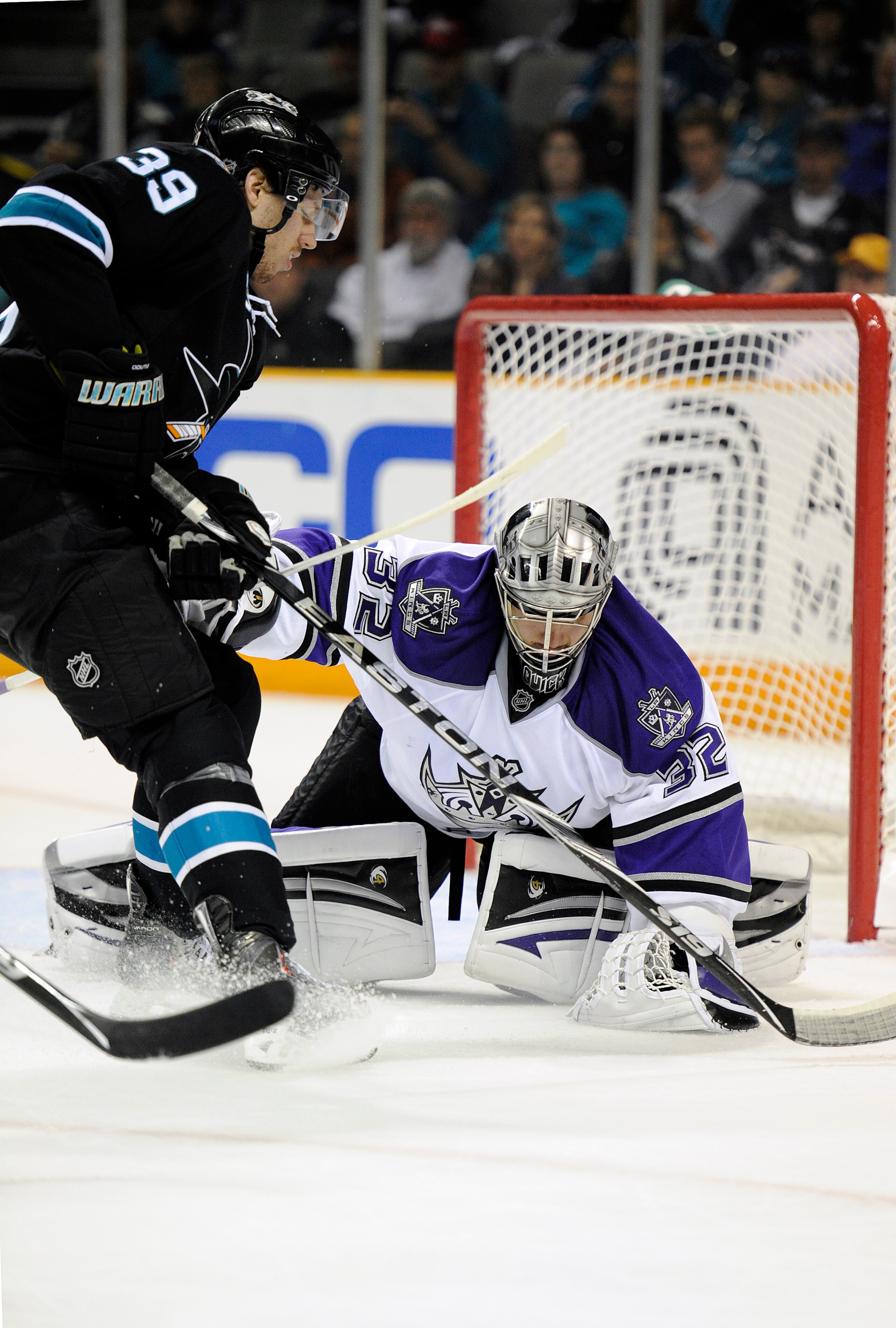 SAN JOSE, CA - APRIL 16: Jonathan Quick #32 of the Los Angeles Kings makes a glove hand save in front of Logan Couture #39 of the San Jose Sharks in Game Two of the Western Conference Quarterfinals  during the 2011 NHL Stanley Cup Playoffs at the HP Pavil