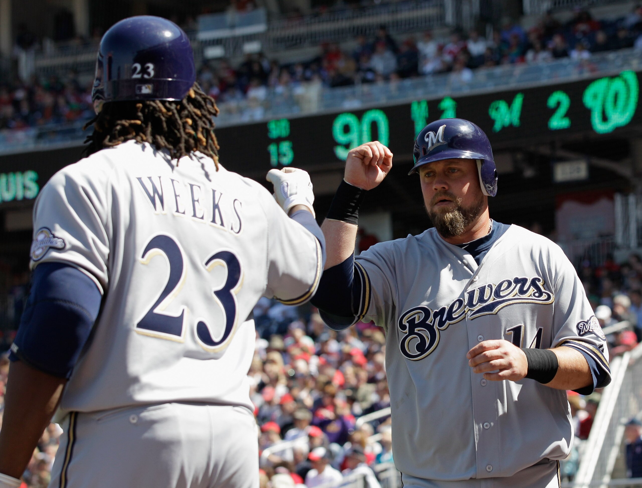 WASHINGTON, DC - APRIL 17: Casey McGehee #14 (R) celebrates scoring in the fourth inning with teammates Rickie Weeks #23 of the Milwaukee Brewers against the Washington Nationals during the first game of a doubleheader at Nationals Park on April 17, 201 WASHINGTON, DC - APRIL 17: Casey McGehee #14 (R) celebrates scoring in the fourth inning with teammates Rickie Weeks #23 of the Milwaukee Brewers against the Washington Nationals during the first game of a doubleheader at Nationals Park on April 17, 201