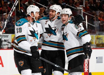 PHILADELPHIA - DECEMBER 08:  Joe Thornton #19, Niclas Wallin #7 and Jason Demers #60 of the San Jose Sharks celebrate Ryan Clowe (not shown) first period goal against the Philadelphia Flyers on December 8, 2010 at the Wells Fargo Center in Philadelphia, P