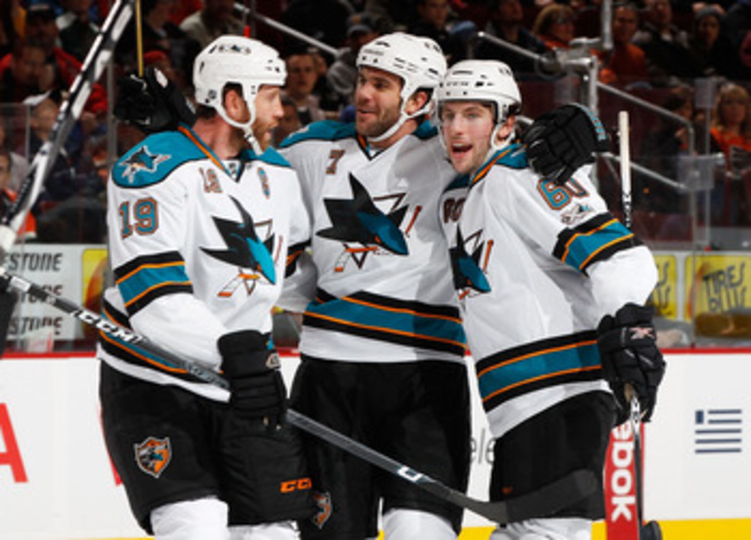 PHILADELPHIA - DECEMBER 08:  Joe Thornton #19, Niclas Wallin #7 and Jason Demers #60 of the San Jose Sharks celebrate Ryan Clowe (not shown) first period goal against the Philadelphia Flyers on December 8, 2010 at the Wells Fargo Center in Philadelphia, P