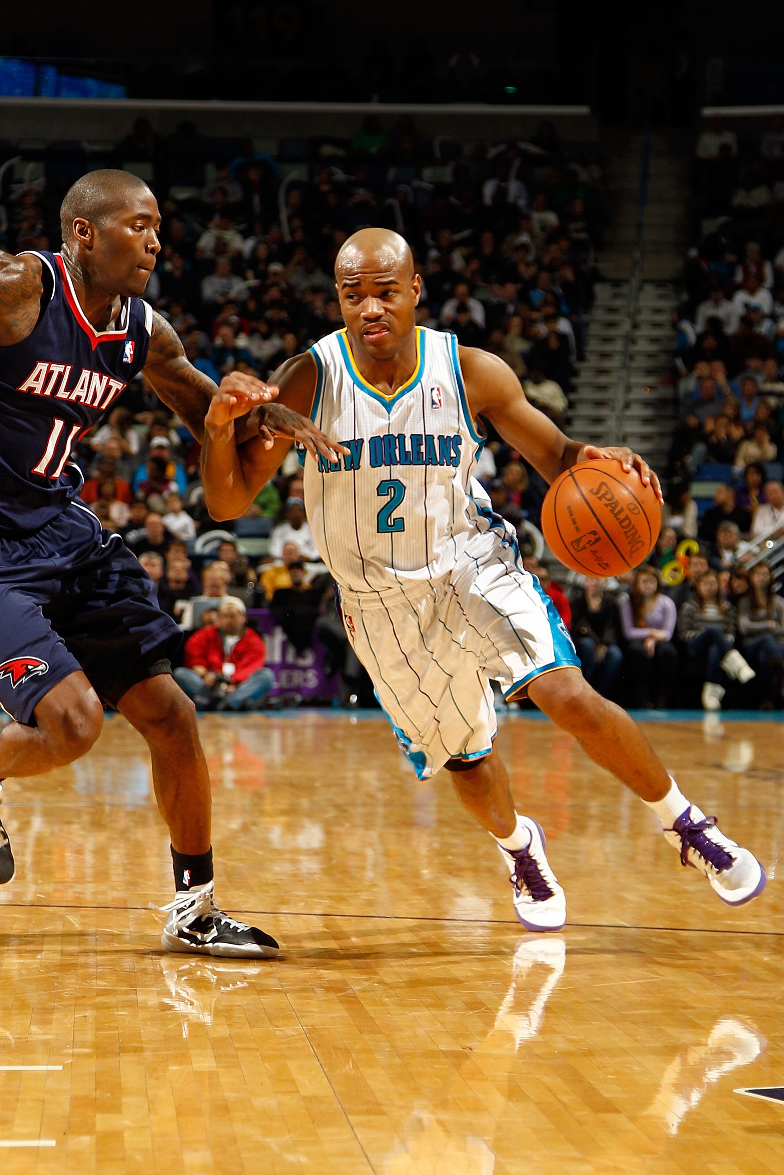 NEW ORLEANS, LA - DECEMBER 26:  Jarrett Jack #2  of the New Orleans Hornets drives the ball around Jamal Crawford #11 of the Atlanta Hawks at the New Orleans Arena on December 26, 2010 in New Orleans, Louisiana.  The Hornets defeated the Hawks 93-86.  NOT