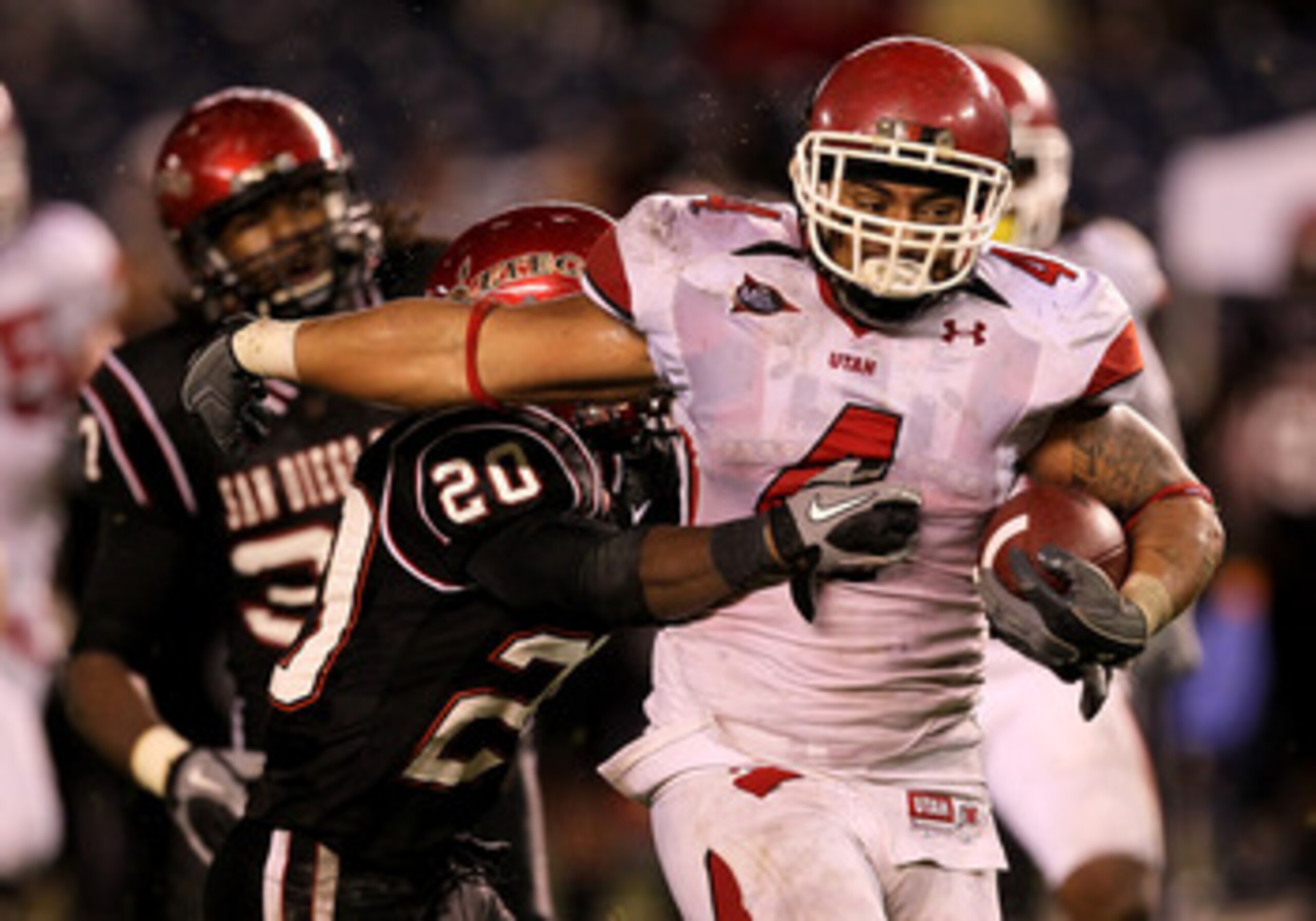 SAN DIEGO - NOVEMBER 20:  Running back Matt Asiata #4 of the Utah Utes carries the ball against defensive back Nat Berhe #20 of the San Diego State Aztecs at Qualcomm Stadium on November 20, 2010 in San Diego, California.  Utah won 38-34.  (Photo by Steph