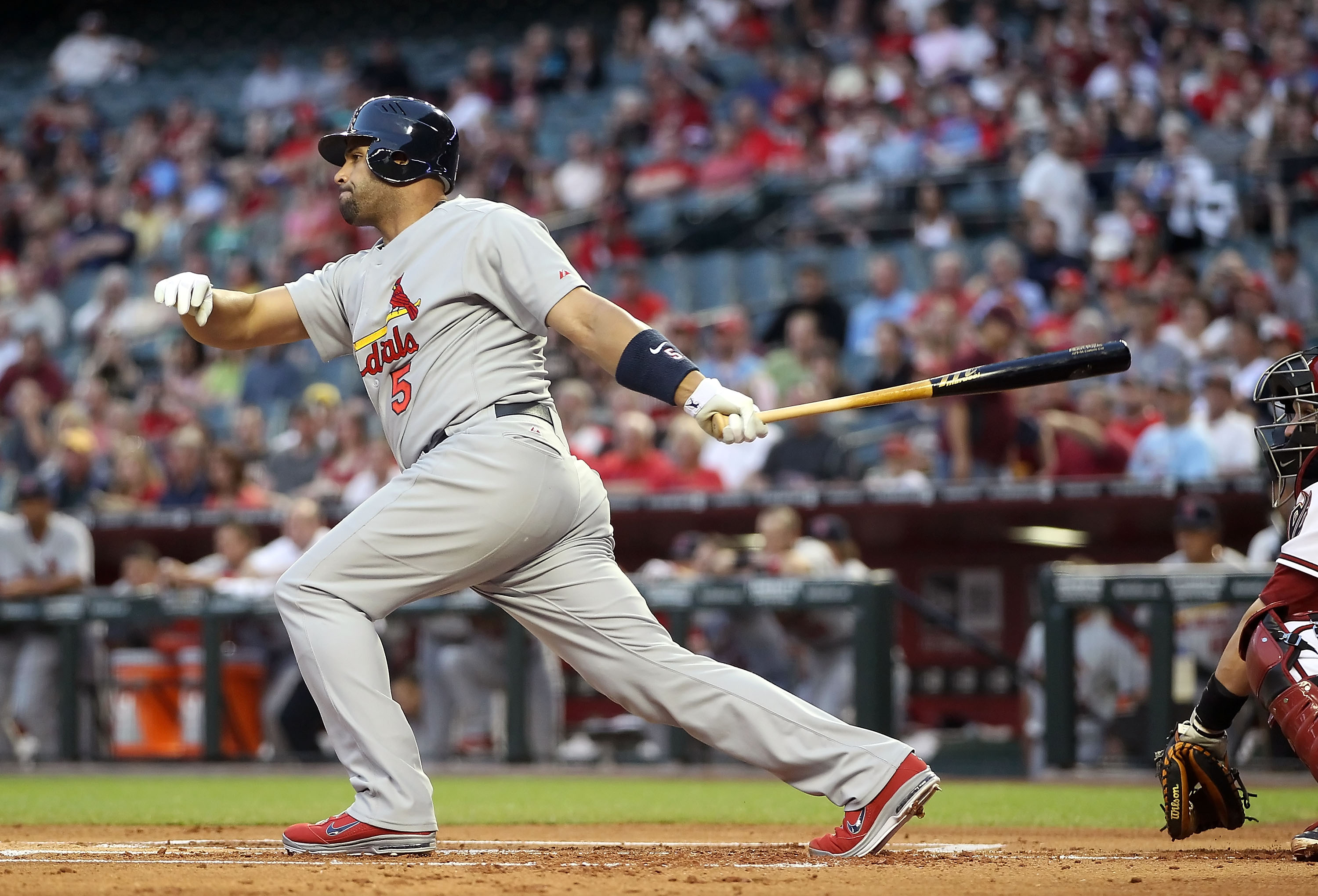 PHOENIX, AZ - APRIL 12:  Albert Pujols #5 of the St. Louis Cardinals hits a single against the Arizona Diamondbacks during the first inning of the Major League Baseball game at Chase Field on April 12, 2011 in Phoenix, Arizona.  (Photo by Christian Peters