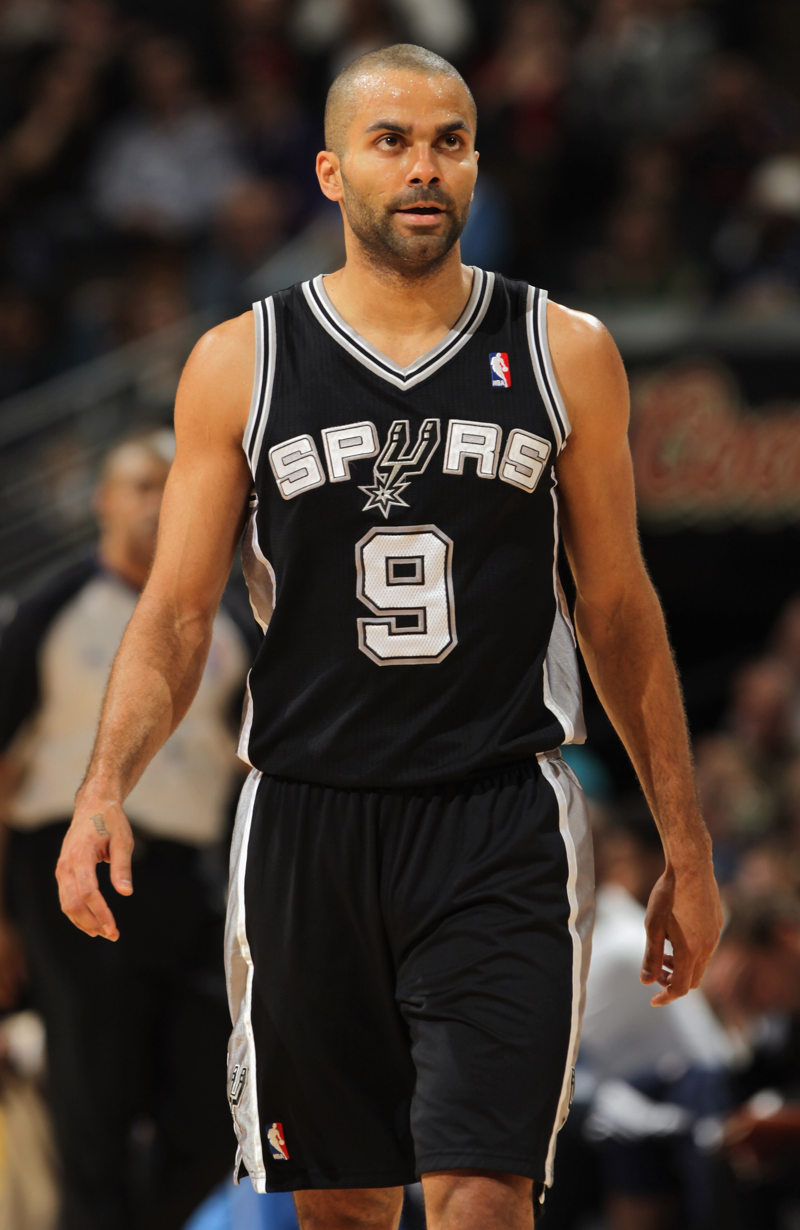 DENVER, CO - MARCH 23:  Tony Parker #9 of the San Antonio Spurs looks on during a break in the against the Denver Nuggets at the Pepsi Center on March 23, 2011 in Denver, Colorado. The Nuggets defeated the Spurs 115-112. NOTE TO USER: User expressly ackno