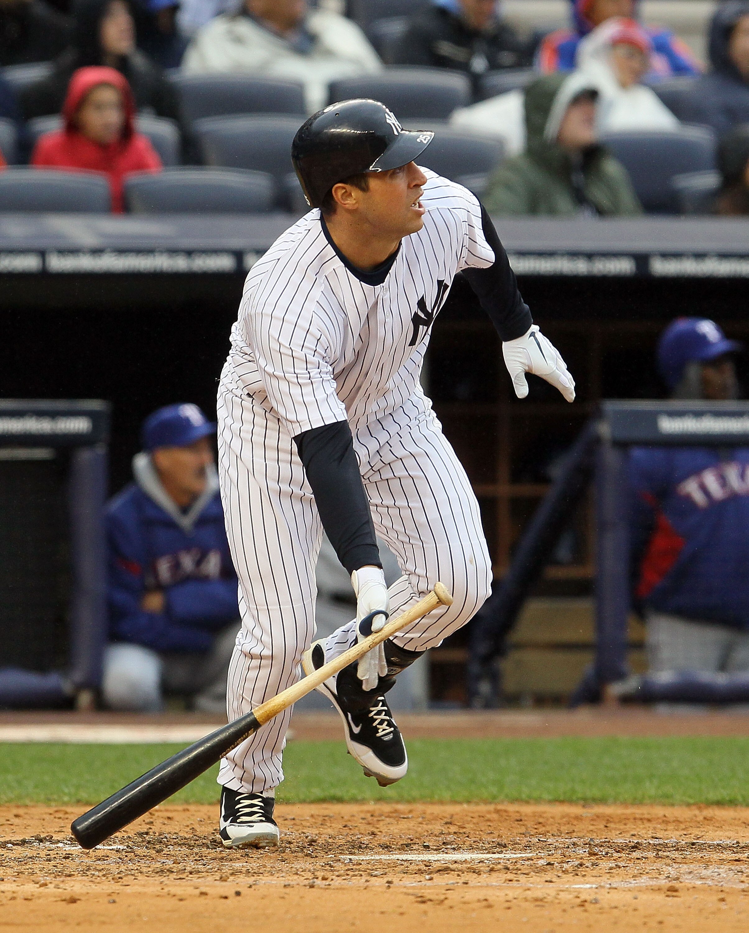 NEW YORK, NY - APRIL 16:  Mark Teixeira #25 of the New York Yankees hits a third-inning scarifice fly against the Texas Rangers on April 16, 2011 at Yankee Stadium in the Bronx borough of New York City.  (Photo by Jim McIsaac/Gett y Images)