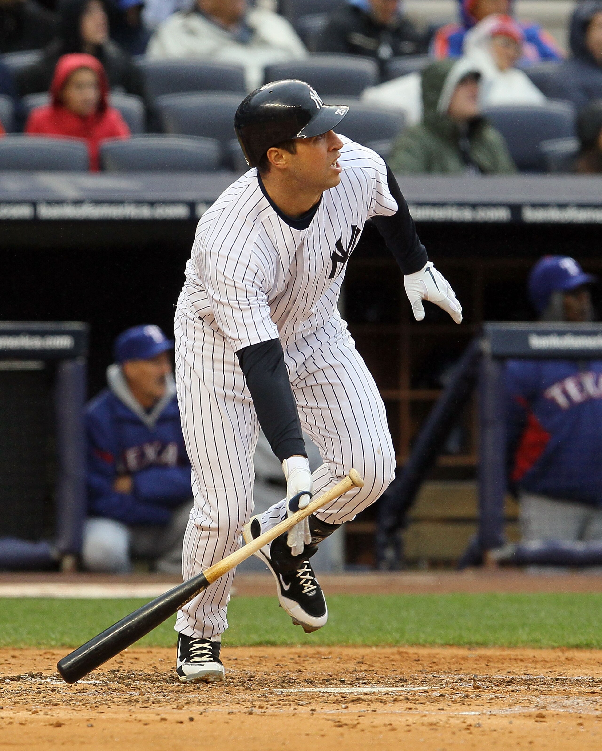 NEW YORK, NY - APRIL 16:  Mark Teixeira #25 of the New York Yankees hits a third-inning scarifice fly against the Texas Rangers on April 16, 2011 at Yankee Stadium in the Bronx borough of New York City.  (Photo by Jim McIsaac/Gett y Images)