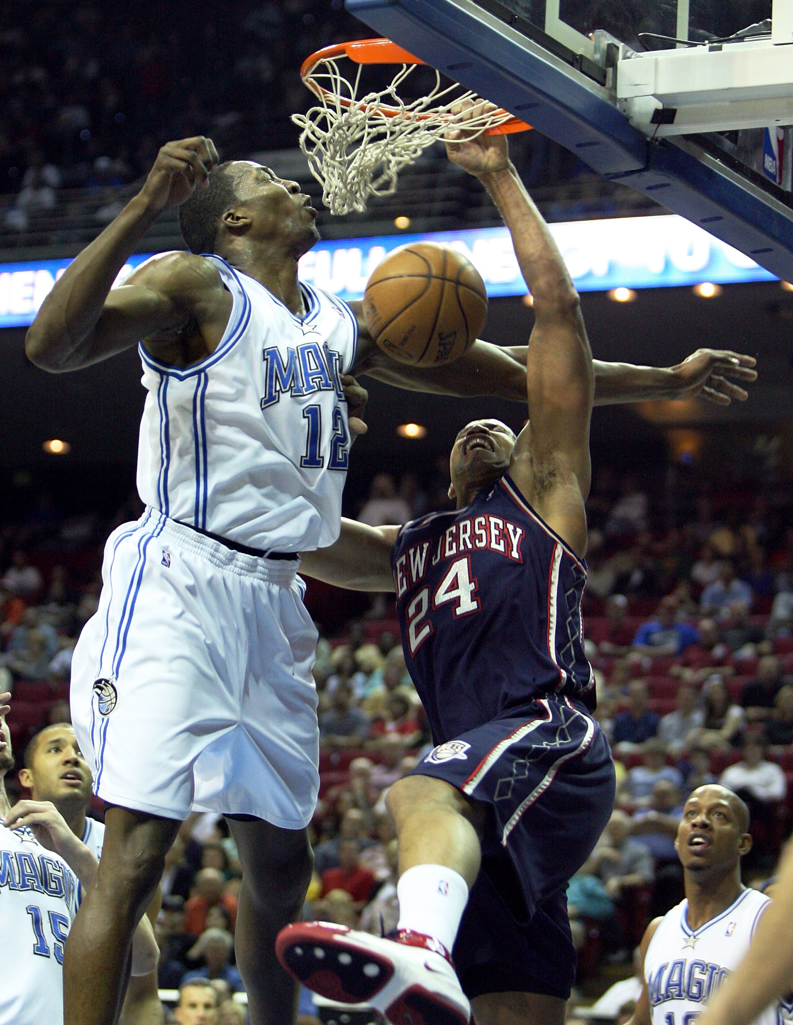 ORLANDO, FL - FEBRUARY 06:  Richard Jefferson #24 of the New Jersey Nets is fouled as he dunks on Dwight Howard #12 of the Orlando Magic at Amway Arena on February 6, 2008 in Orlando, Florida. NOTE TO USER: User expressly acknowledges and agrees that, by
