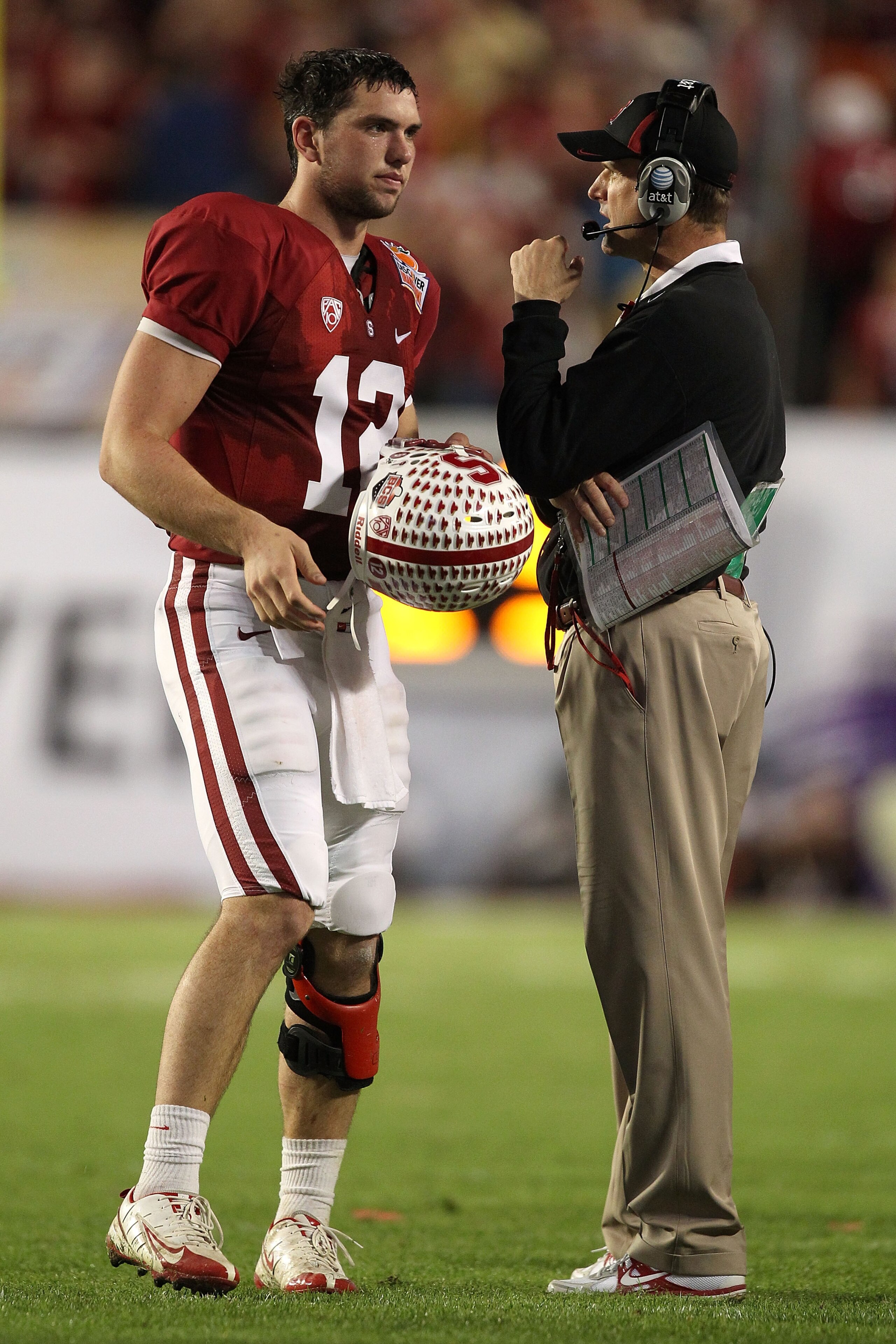 MIAMI, FL - JANUARY 03:  (L-R) Quarterback Andrew Luck and head coach Jim Harbaugh of the Stanford Cardinal talk against the Virginia Tech Hokies during the 2011 Discover Orange Bowl at Sun Life Stadium on January 3, 2011 in Miami, Florida. Stanford won 4