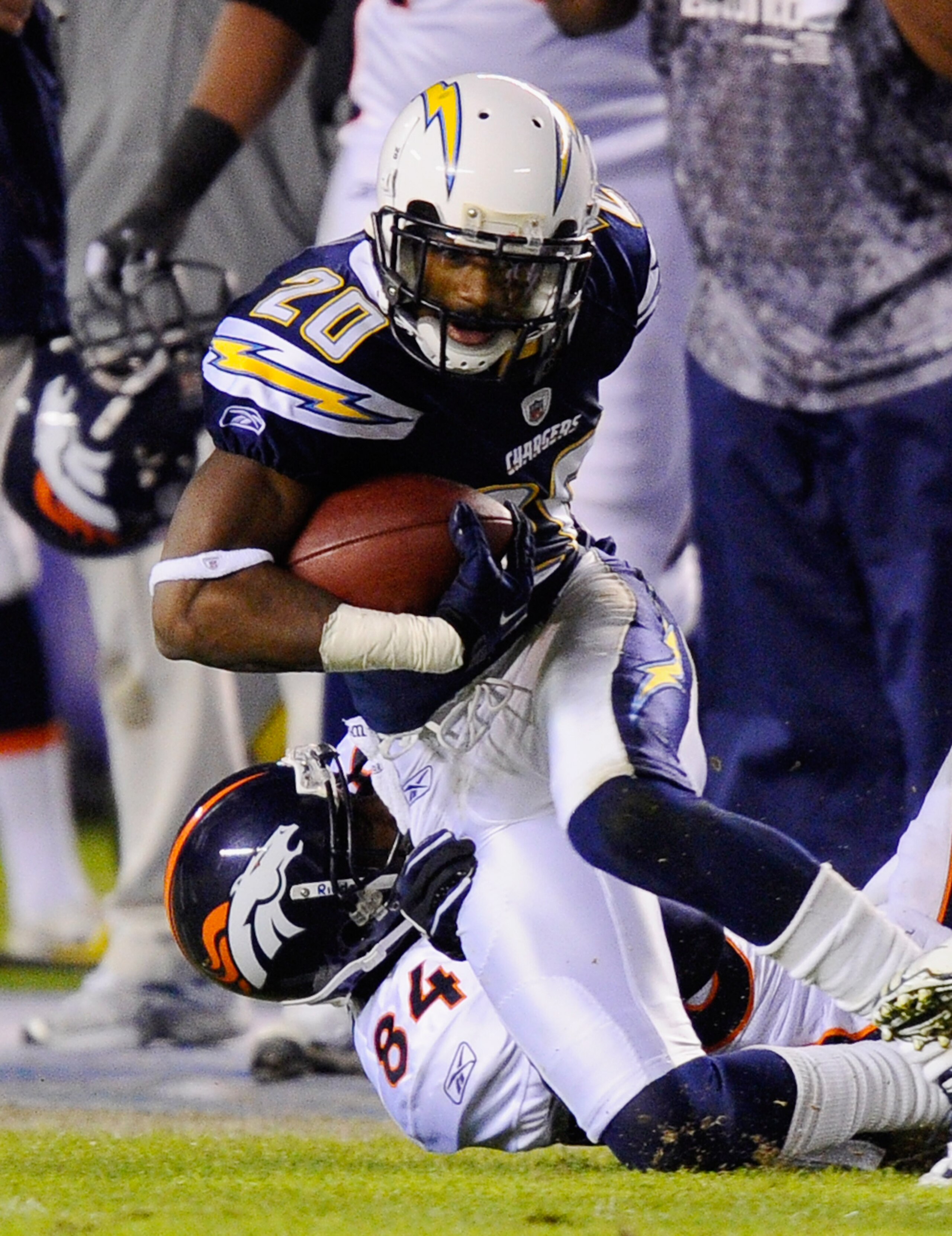SAN DIEGO - NOVEMBER 22: Corner back Antoine Cason #20 of the San Diego Chargers is tackled by Bradon Lloyd #84 of the Denver Broncos after intercepting a pass at Qualcomm Stadium on November 22, 2010 in San Diego, California.  (Photo by Kevork Djansezian