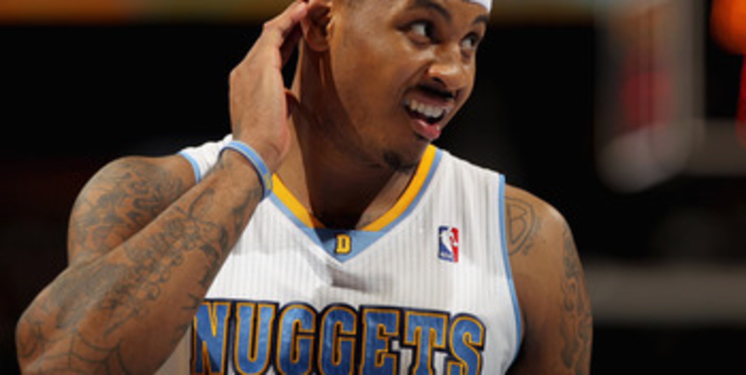 DENVER, CO - FEBRUARY 10:  Carmelo Anthony #15 of the Denver Nuggets looks on during a break in the action against the Dallas Mavericks during NBA action at the Pepsi Center on February 10, 2011 in Denver, Colorado. The Nuggets defeated the Mavericks 121-