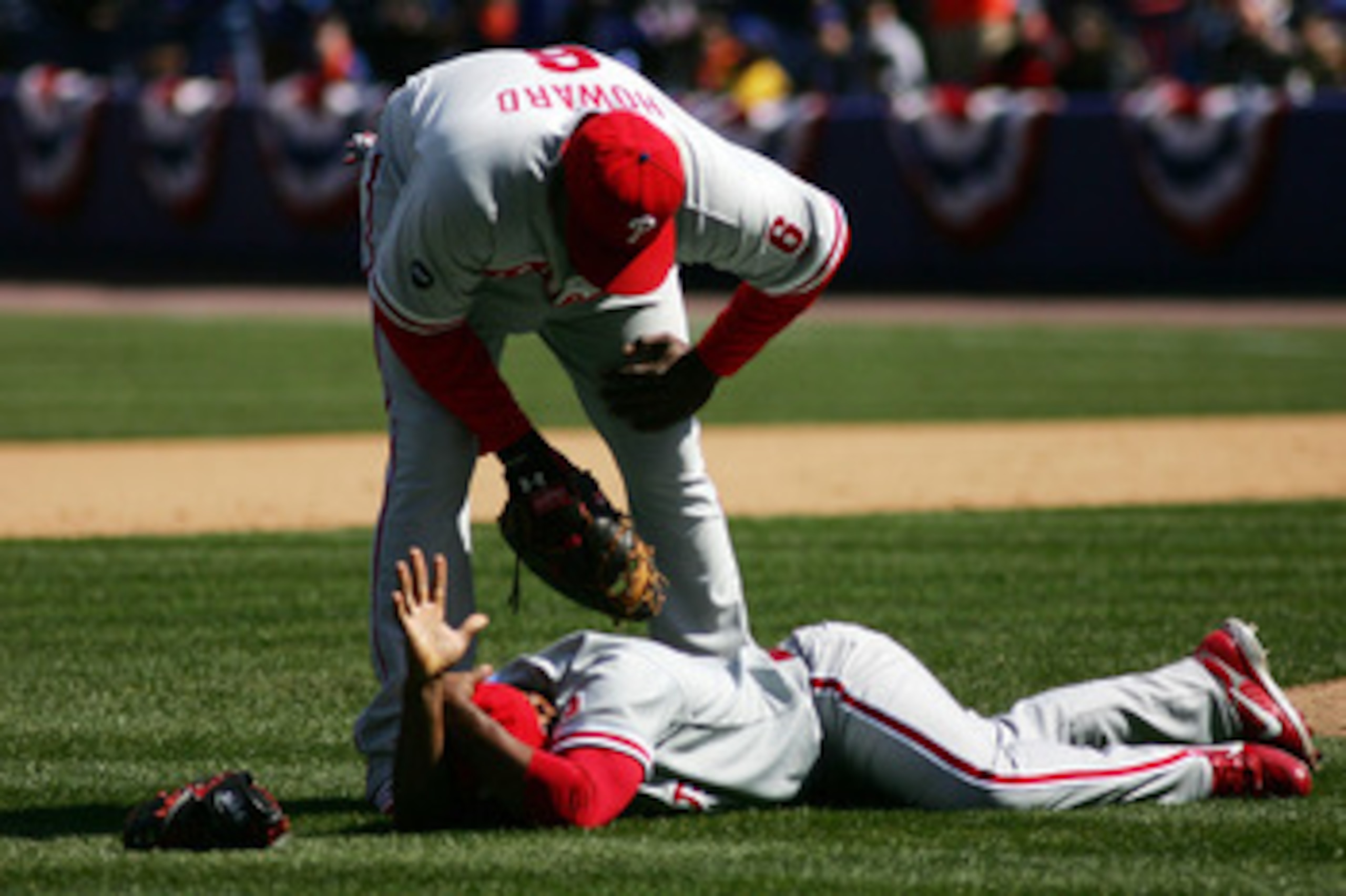 NEW YORK - APRIL 09:  Ryan Howard #6 of the Philadelphia Phillies checks on Abraham O. Nunez #3 after they collided while trying to field a pop up by Jose Reyes #7 of the New York Mets during the home opener at Shea Stadium on April 9, 2007 in the Flushin