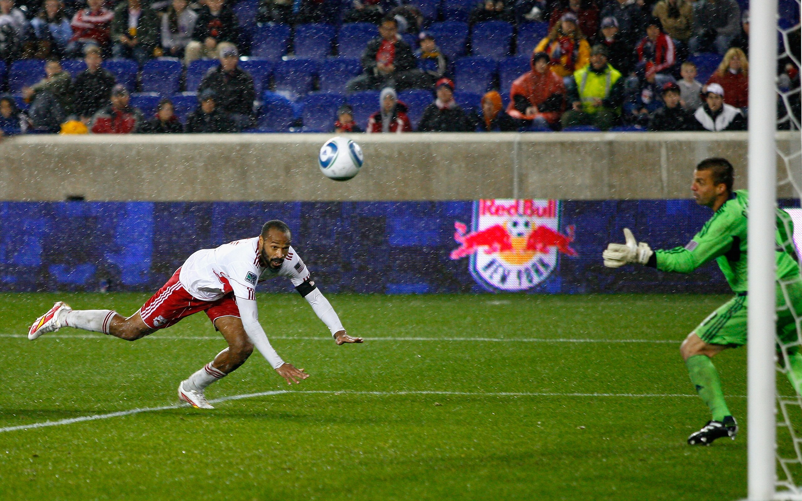 HARRISON, NJ - APRIL 16: Thierry Henry #14 of the New York Red Bulls heads the ball into the net past goalkeeper Jon Busch #18 of the San Jose Earthquakes for a second half goal during the game at Red Bull Arena on April 16, 2011 in Harrison, New Jersey. HARRISON, NJ - APRIL 16: Thierry Henry #14 of the New York Red Bulls heads the ball into the net past goalkeeper Jon Busch #18 of the San Jose Earthquakes for a second half goal during the game at Red Bull Arena on April 16, 2011 in Harrison, New Jersey.