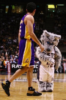 EAST RUTHERFORD, NJ - MARCH 27: New Jersey Nets mascot Mini Sly Fox shows his manners to Jordan Famar #5 of the Los Angeles Lakers during the game on March 27, 2009 at the Izod Center in East Rutherford, New Jersey. NOTE TO USER: User expressly acknowledg