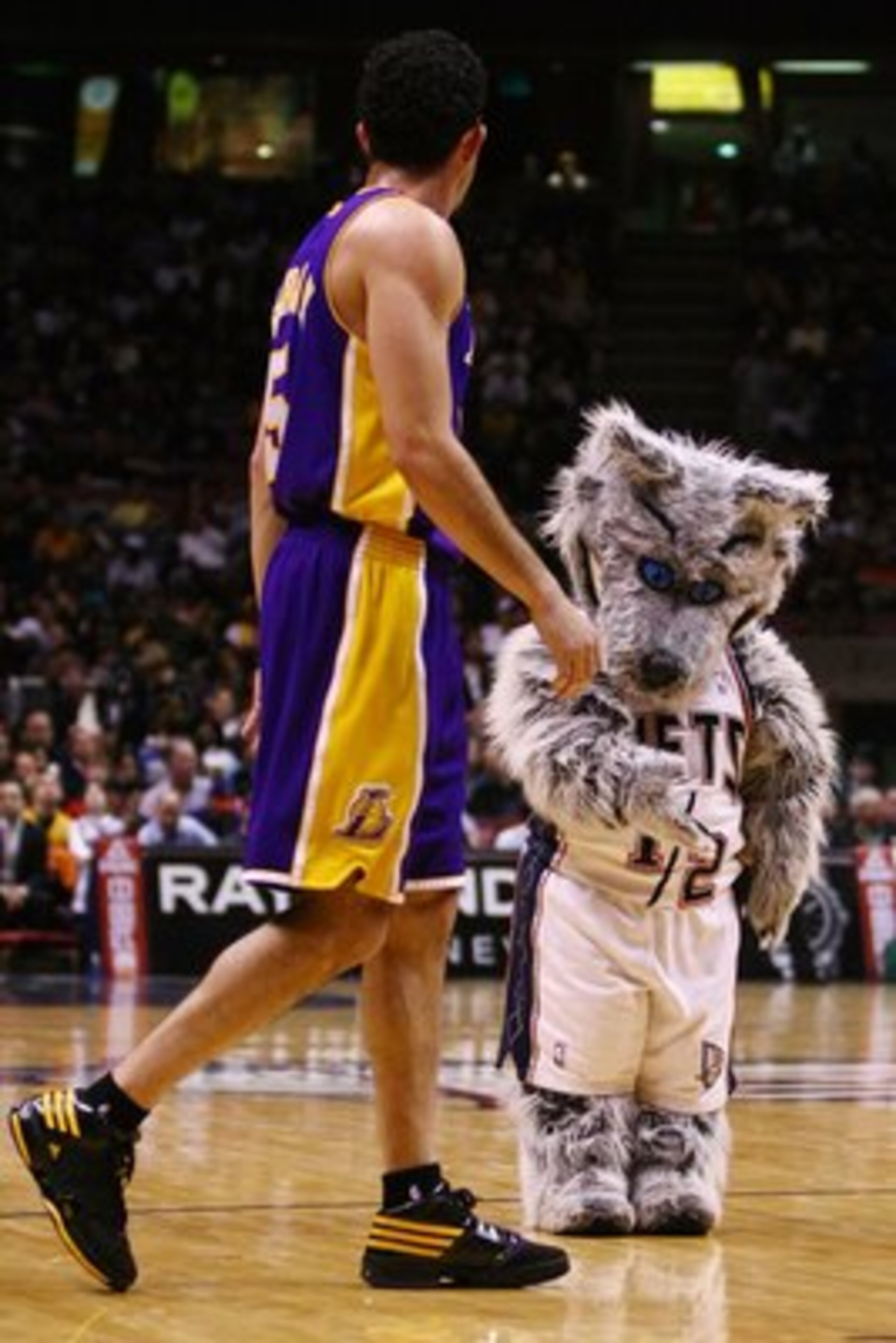 EAST RUTHERFORD, NJ - MARCH 27: New Jersey Nets mascot Mini Sly Fox shows his manners to Jordan Famar #5 of the Los Angeles Lakers during the game on March 27, 2009 at the Izod Center in East Rutherford, New Jersey. NOTE TO USER: User expressly acknowledg