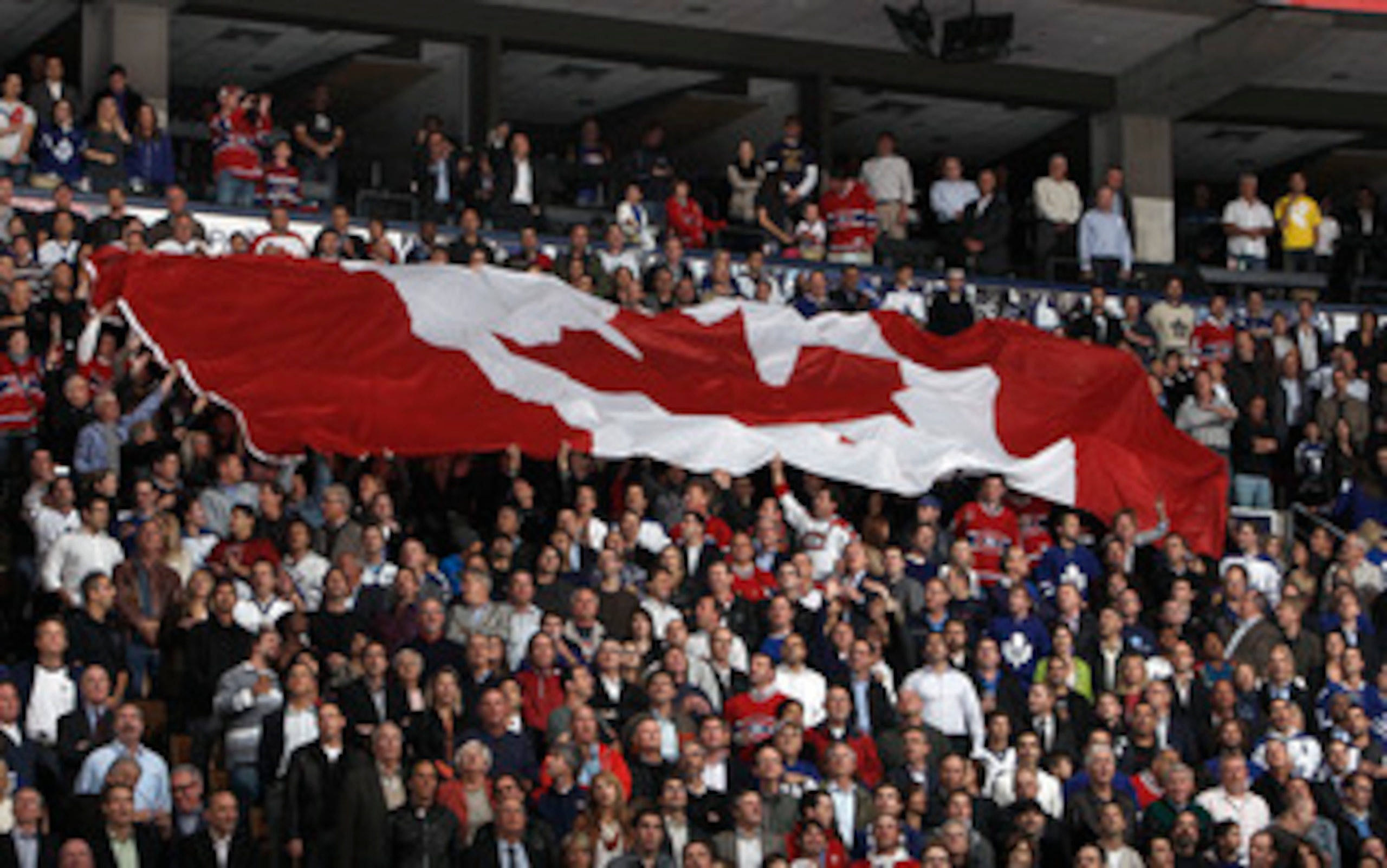 TORONTO, CANADA - OCTOBER 07: A giant Canadian flag is passed around during an opening night pre-game ceremony before a regular season NHL game between the Toronto Maple Leafs  and the Montreal Canadiens at the Air Canada Centre October 7, 2010 in Toronto
