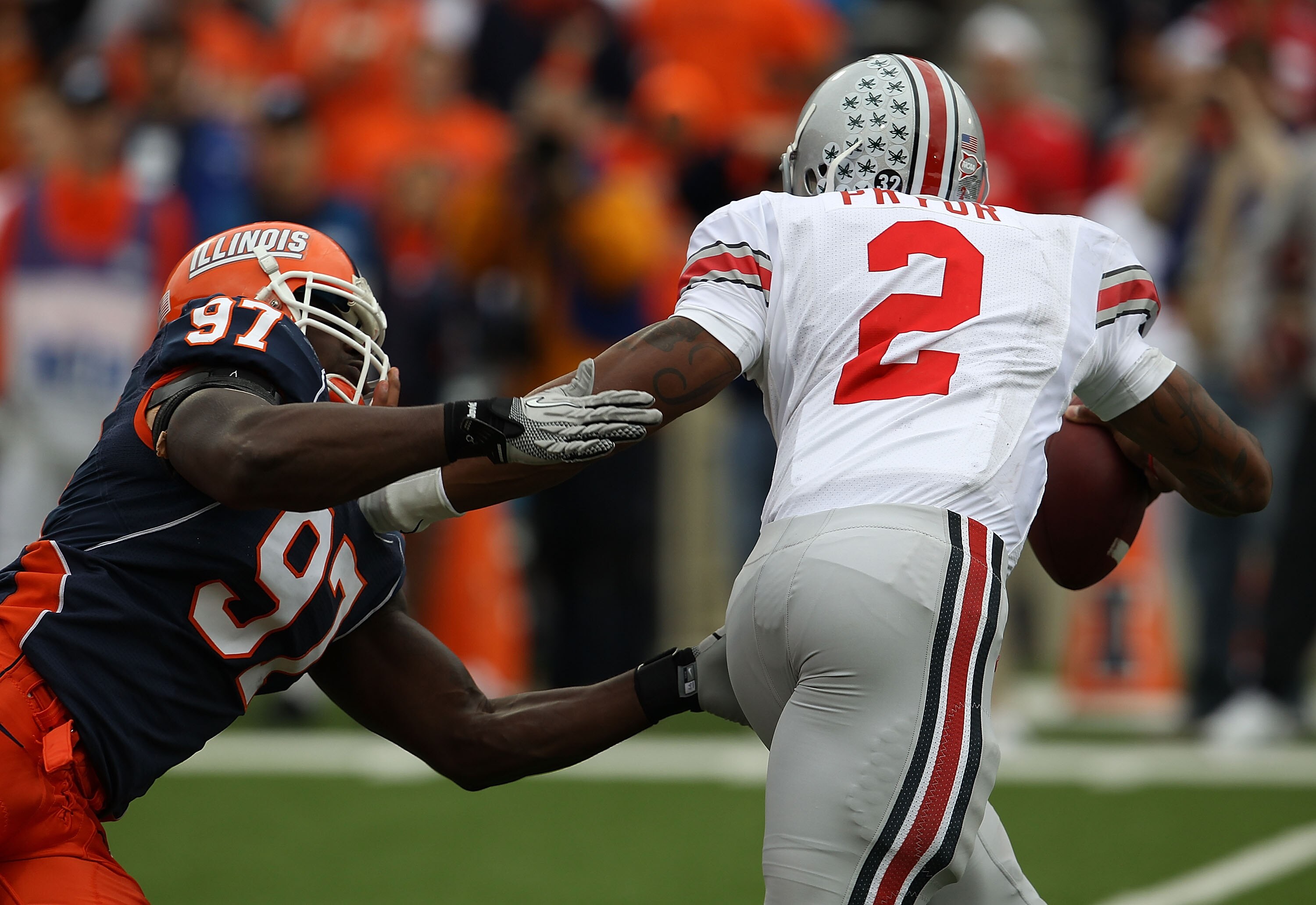 CHAMPAIGN, IL - OCTOBER 02: Terrelle Pryor #2 of the Ohio State Buckeyes avoids a tackle attempt by Clay Nurse #97 of the Illinois Fighting Illini at Memorial Stadium on October 2, 2010 in Champaign, Illinois. Ohio State defeated Illinois 24-13. (Photo by